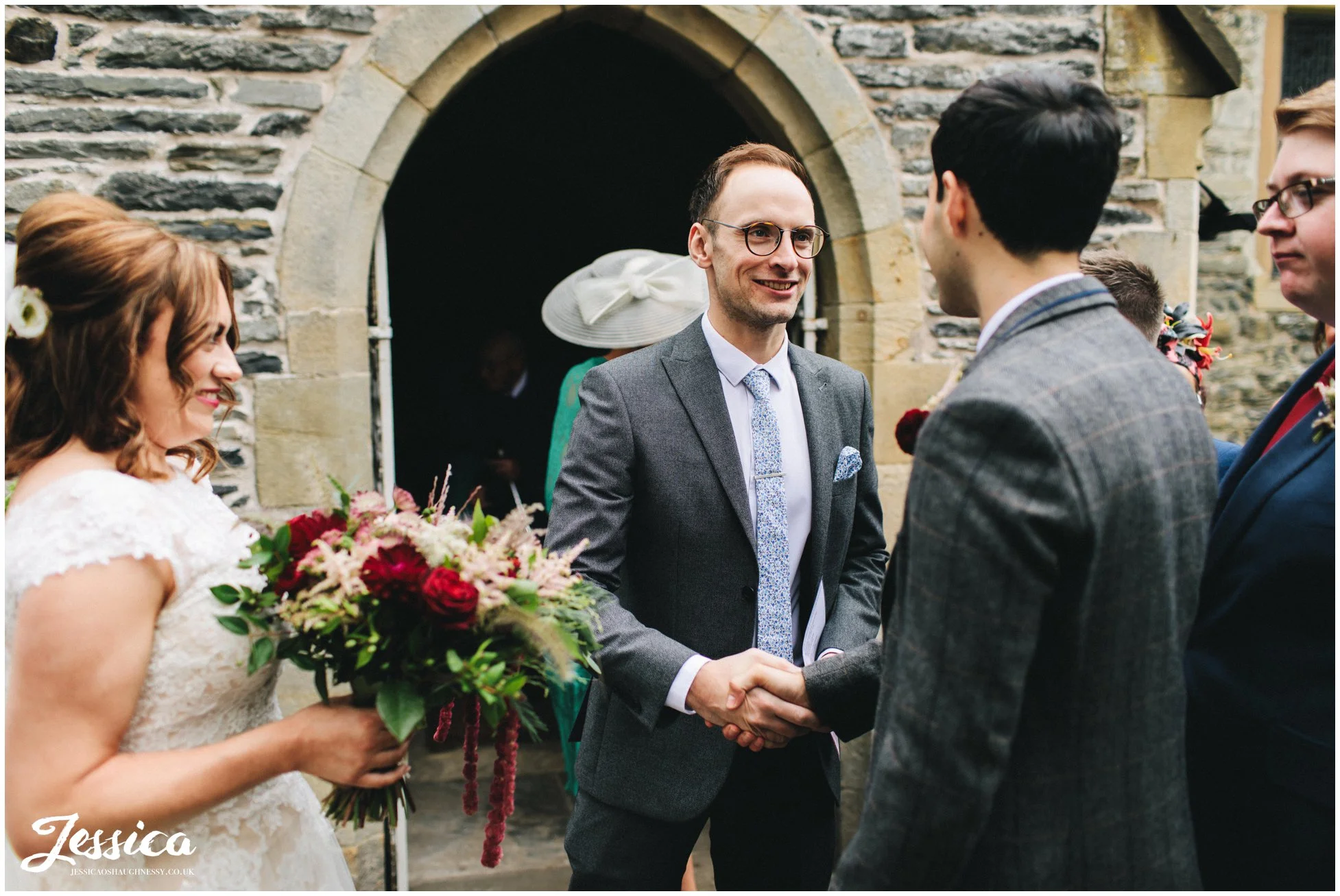 the brides brother shakes the grooms hand