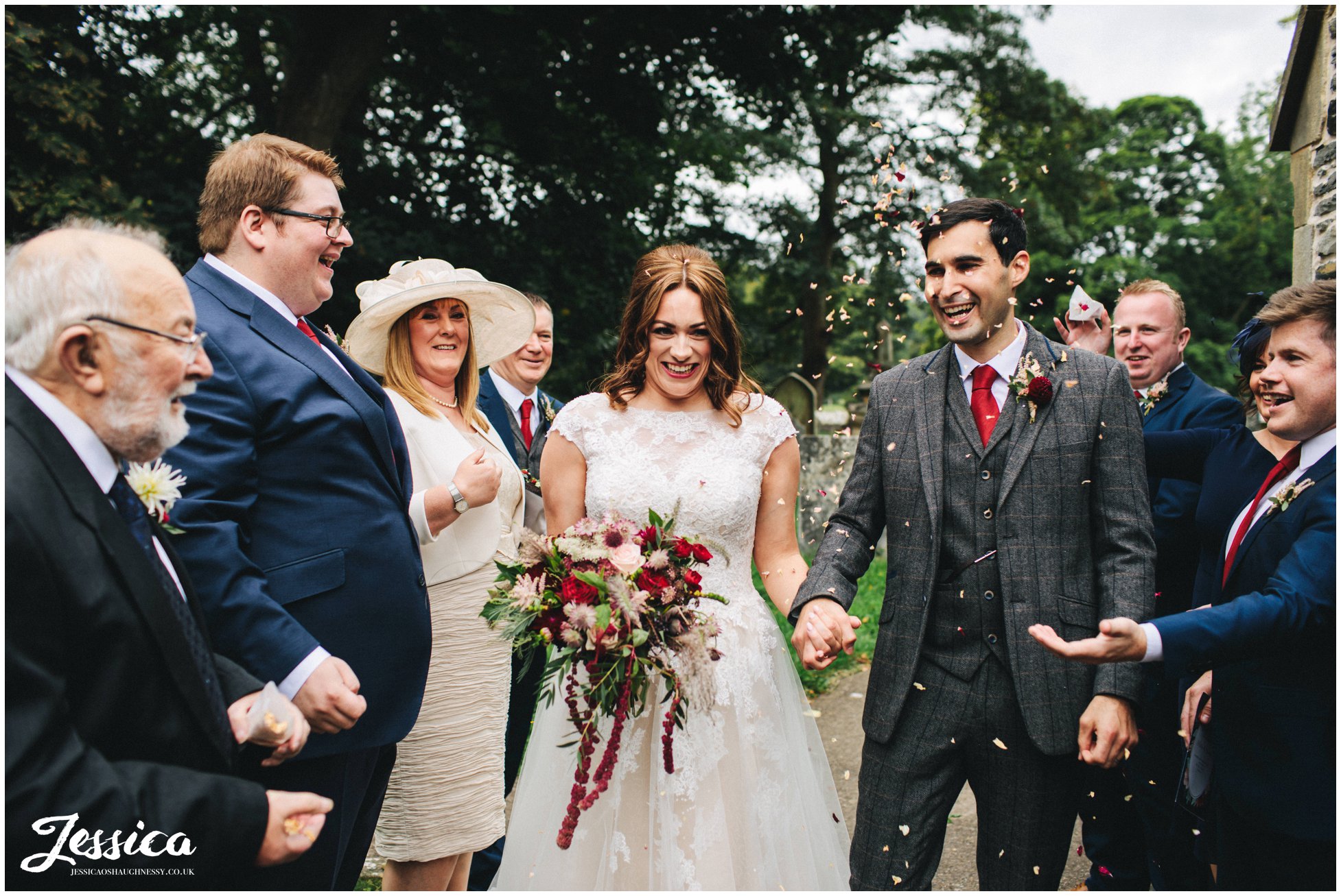 the bride and groom walk through their confetti line