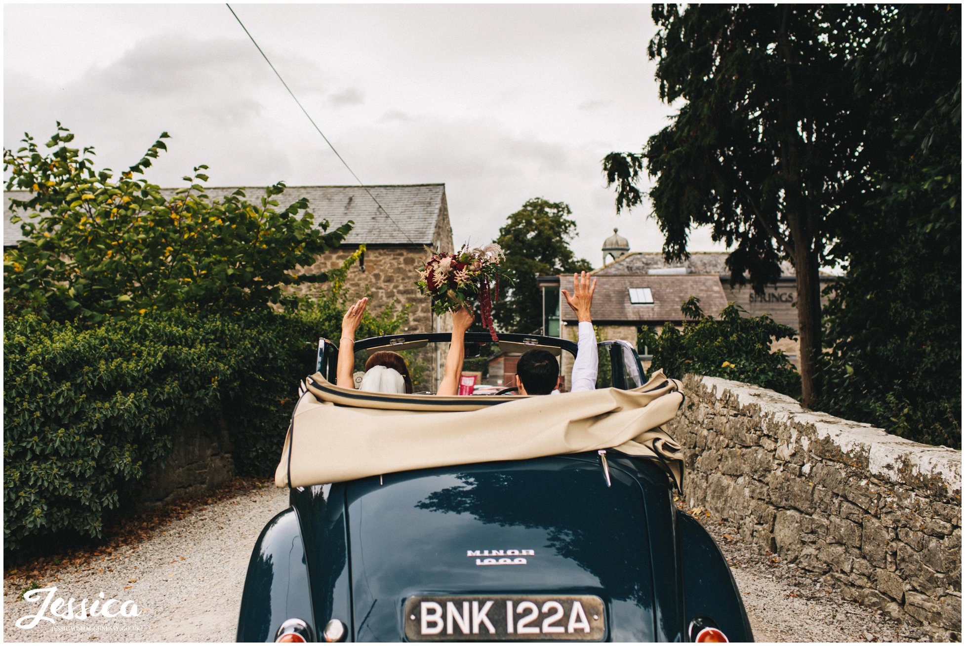 the couple cheer as they arrive at their north wales wedding venue