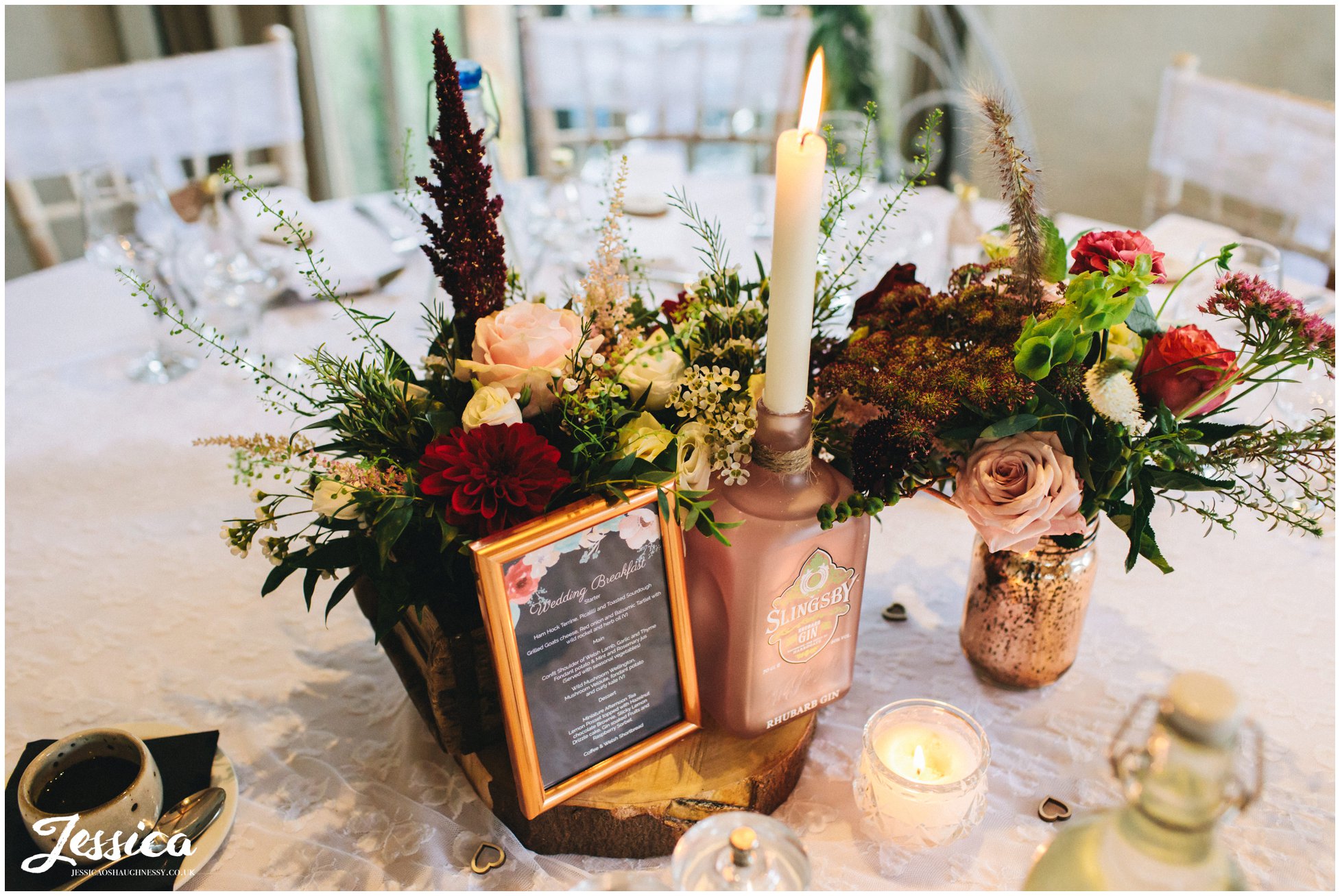 floral displays and gin bottles decorate the tables
