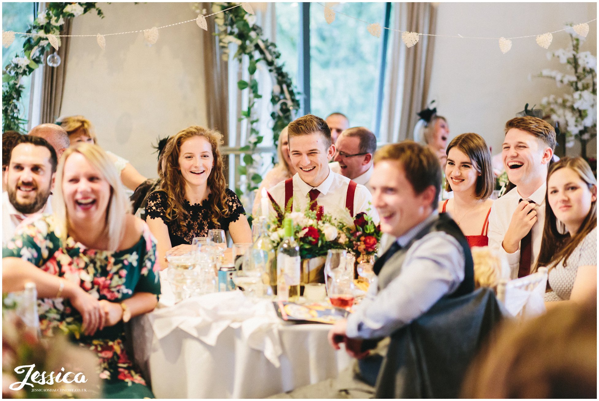 friends of the couple enjoy the funny speeches at Llanrhaeadr Springs in north wales