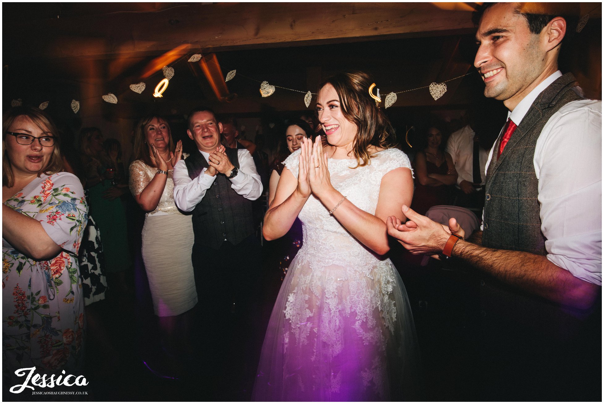 the bride and groom applaud the band at Llanrhaeadr Springs in north wales