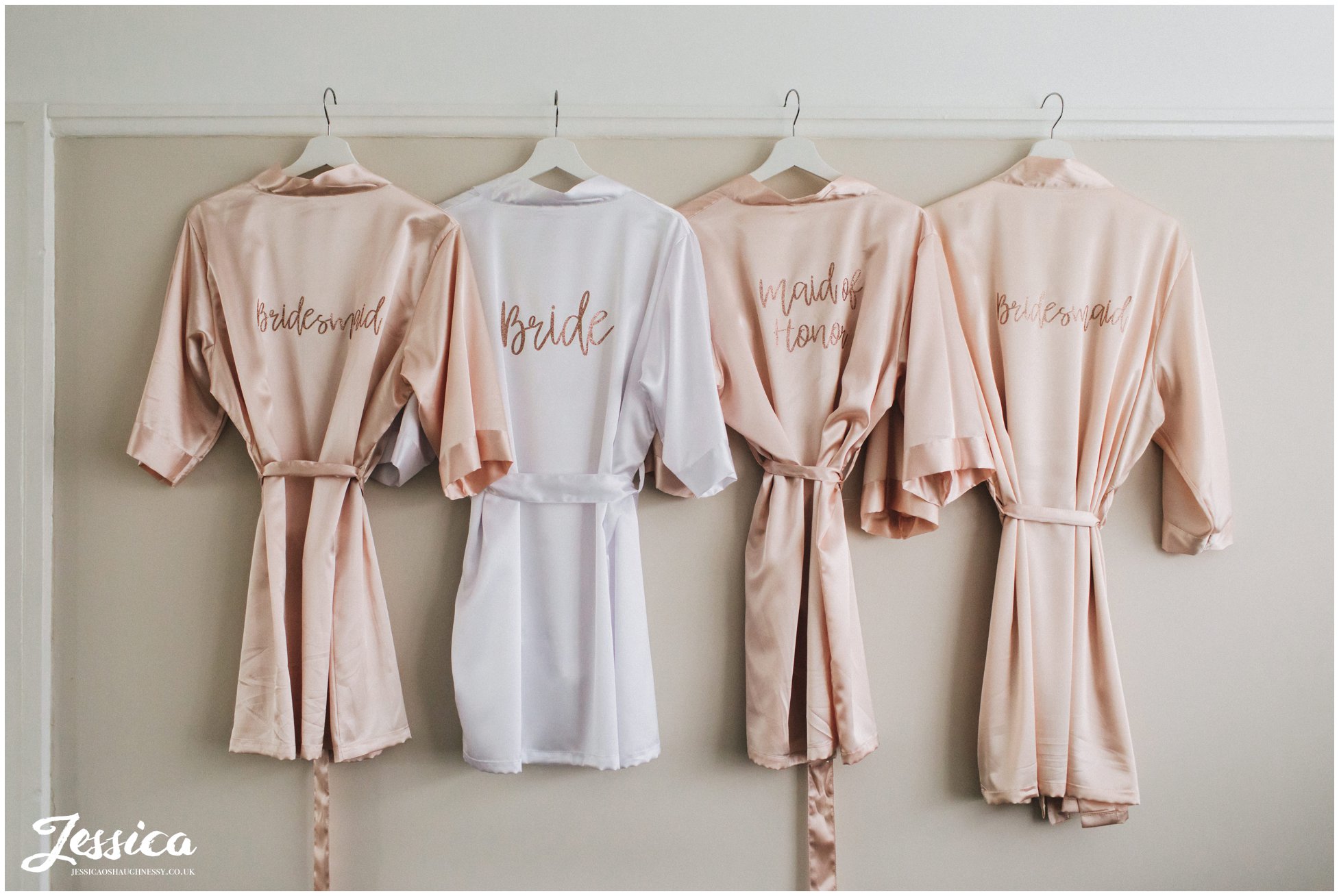 bridal party dressing gowns hanging up during bridal prep