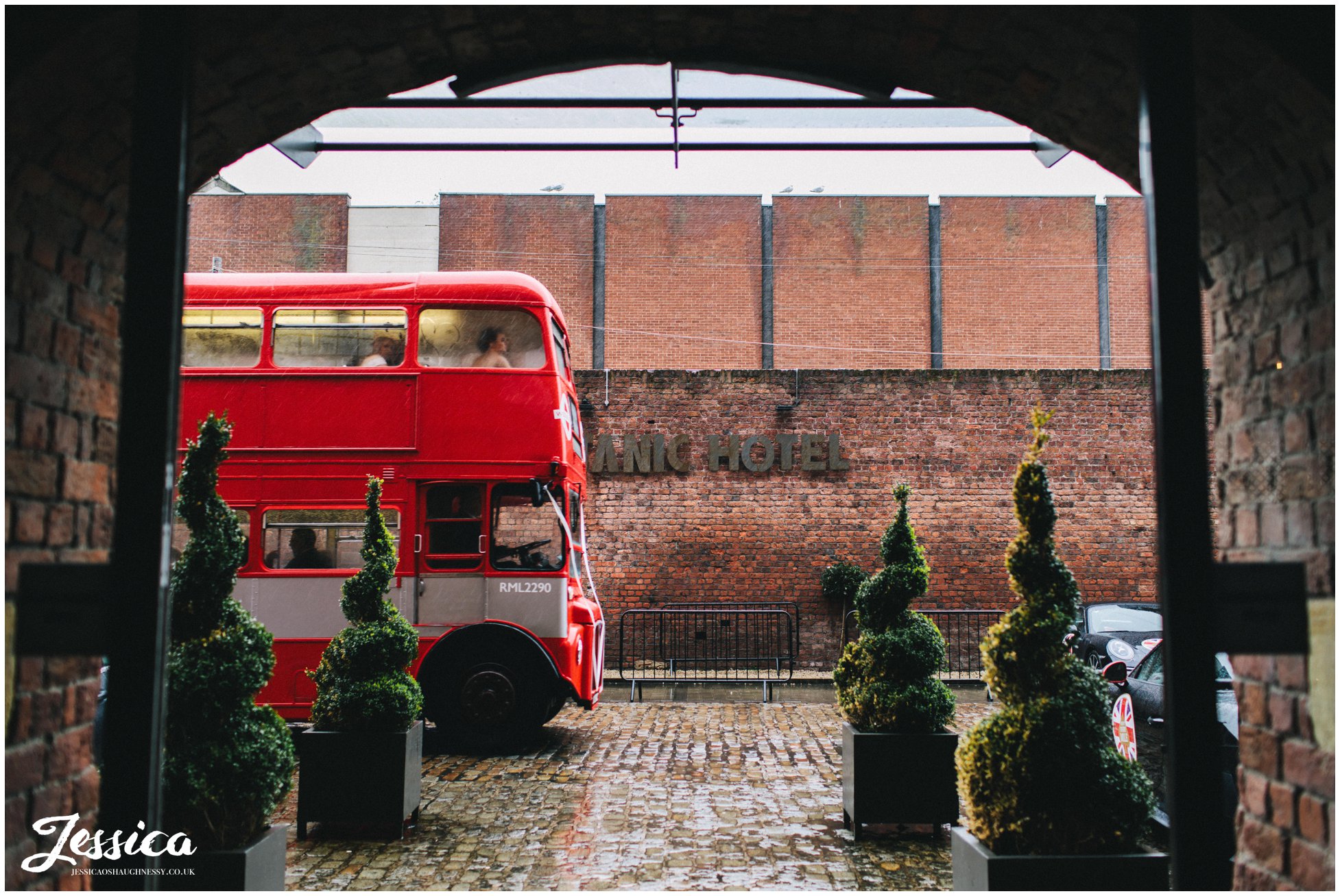 red bus arrives with guests at the titanic hotel in liverpool