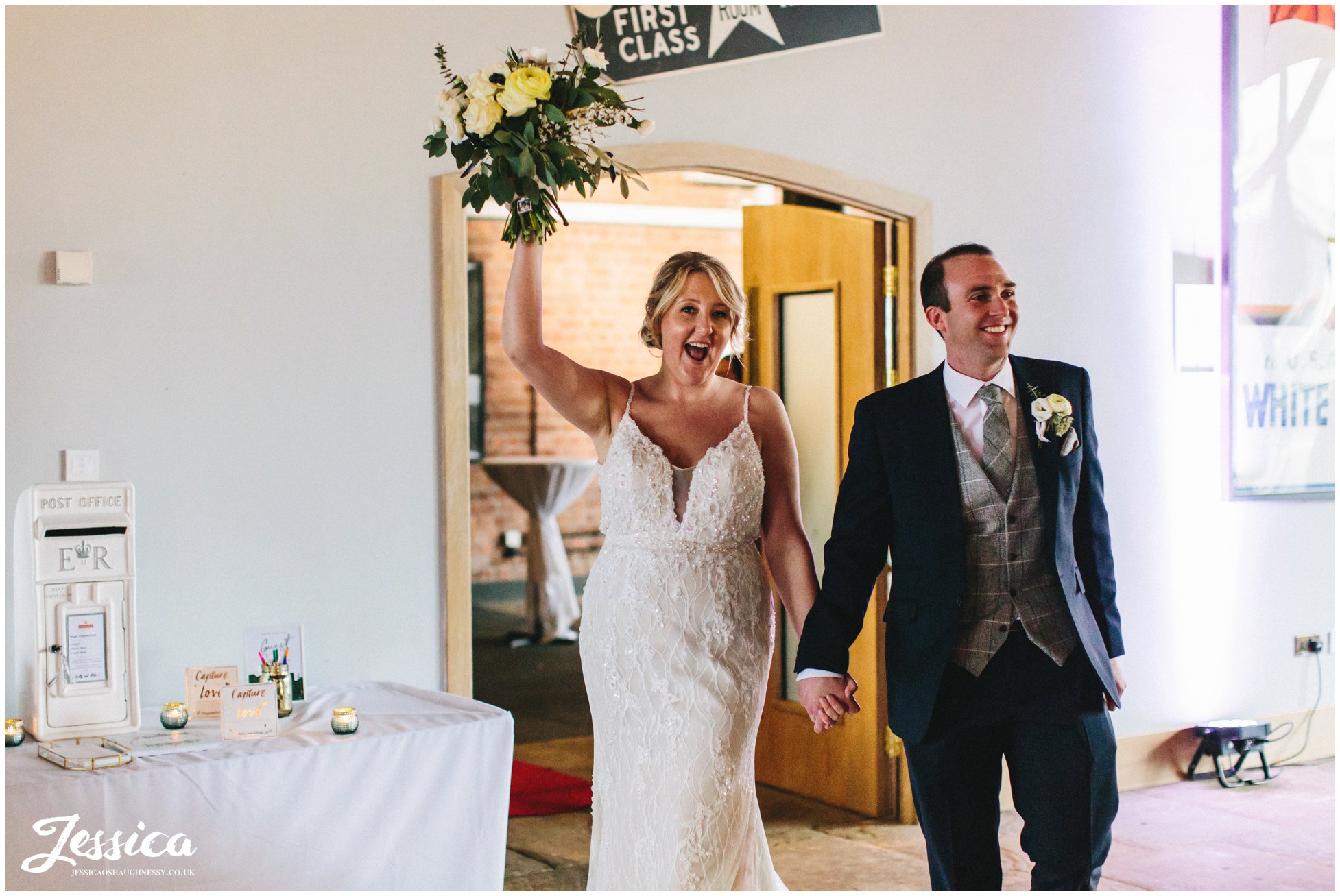 the couple cheer as they are announced in for their wedding breakfast