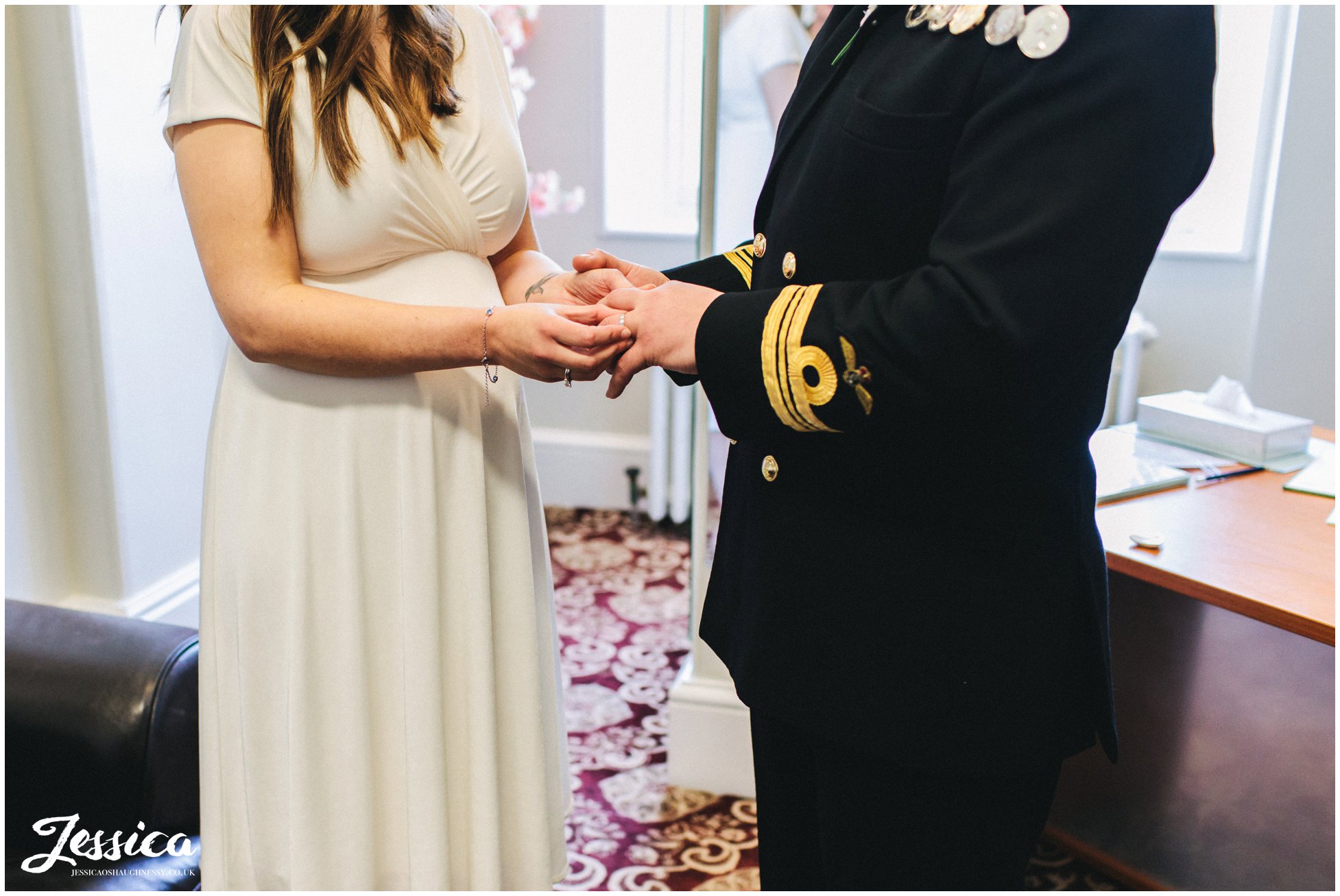 the bride places the ring on the grooms finger
