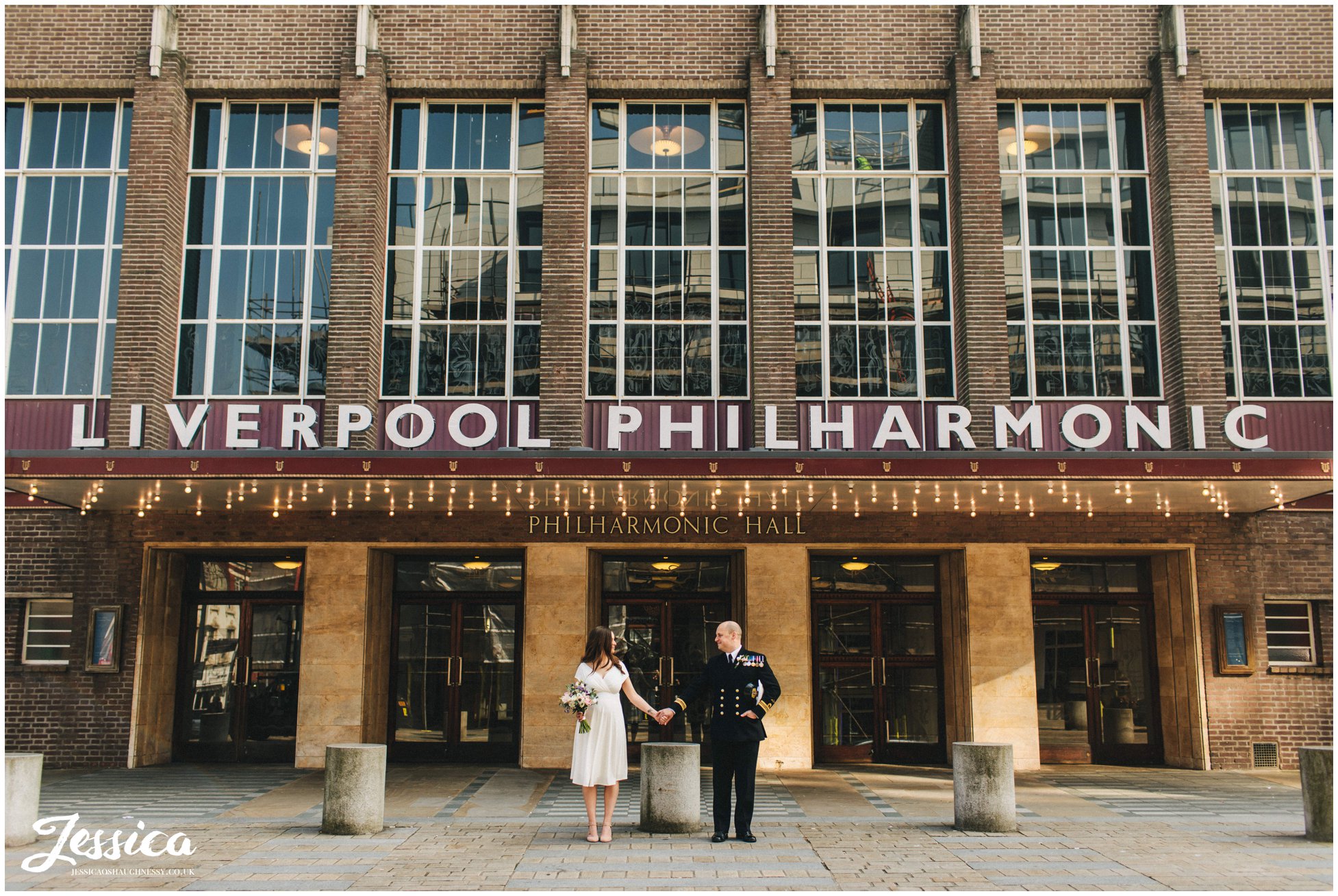 couple stand under the liverpool philharmonic