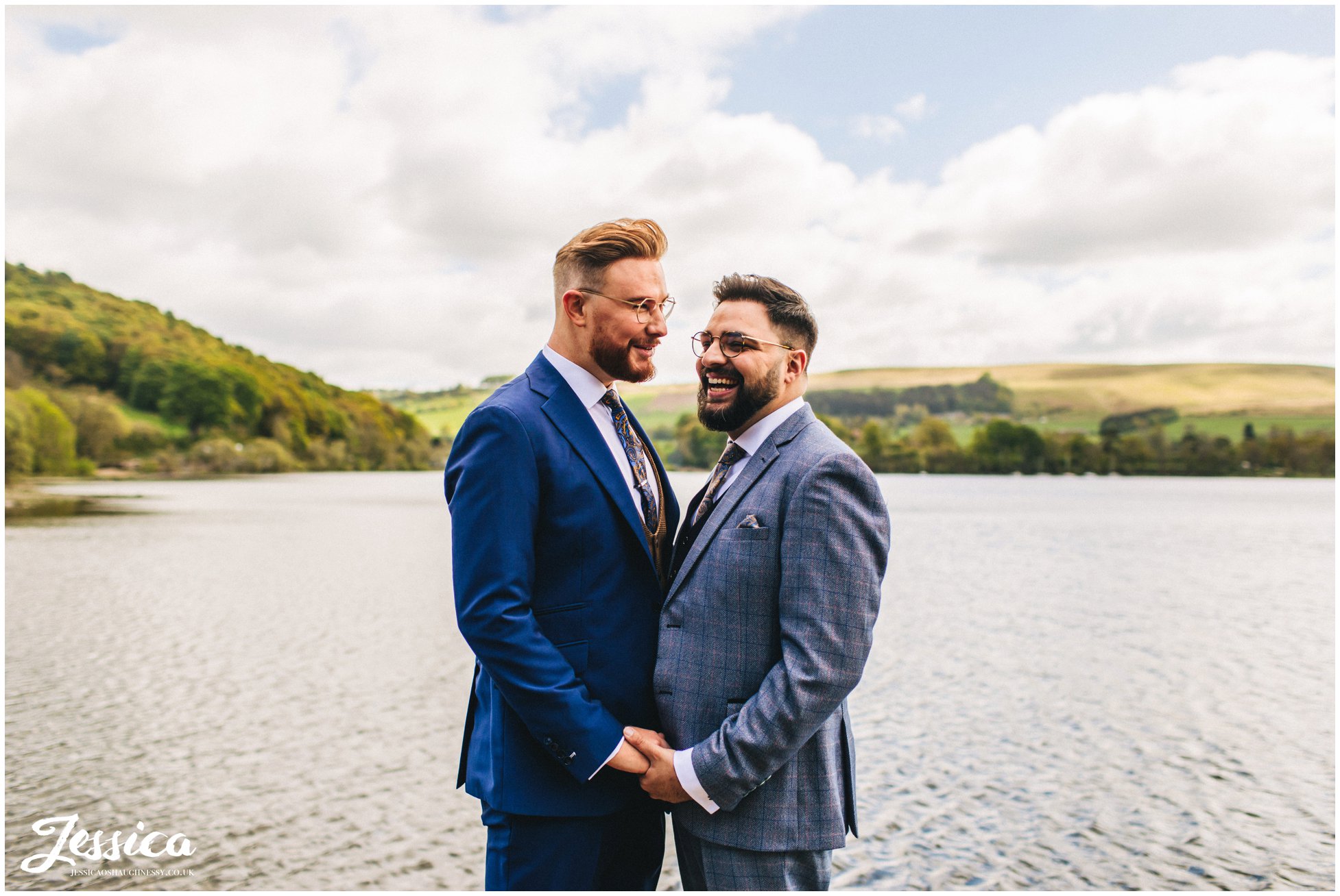 the grooms hold each other before heading to their ceremony in the lakes