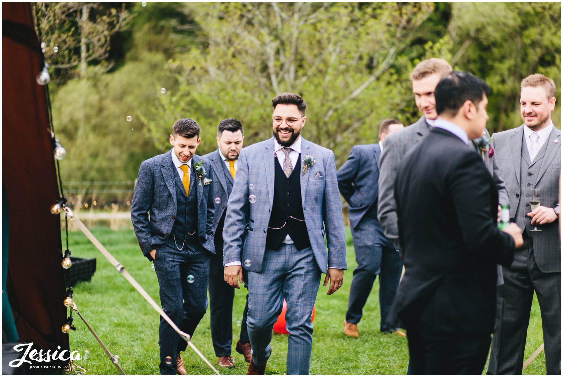 the groom arrives at the tipi set up for their lake district wedding