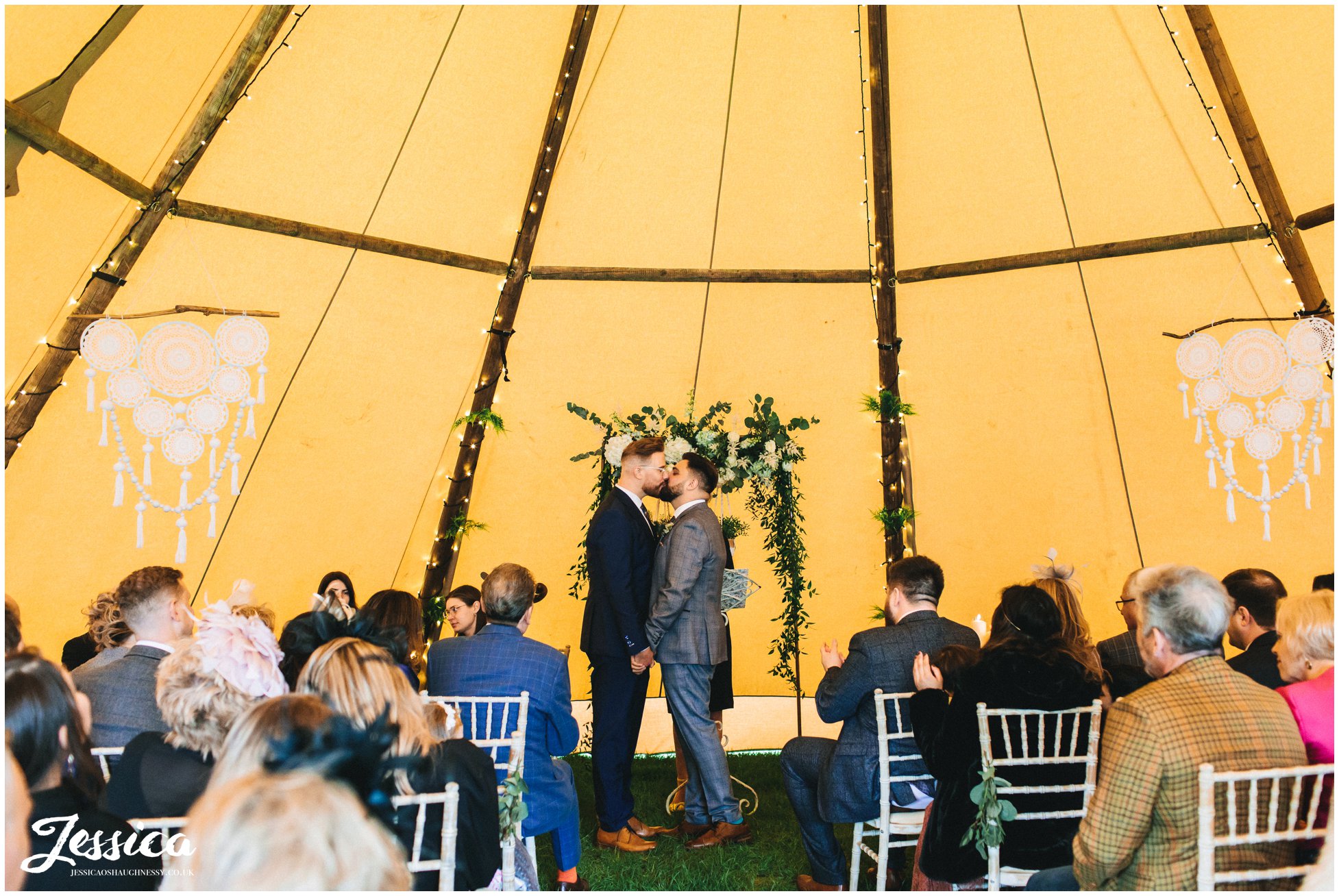 the grooms share their first kiss at the lake district wedding