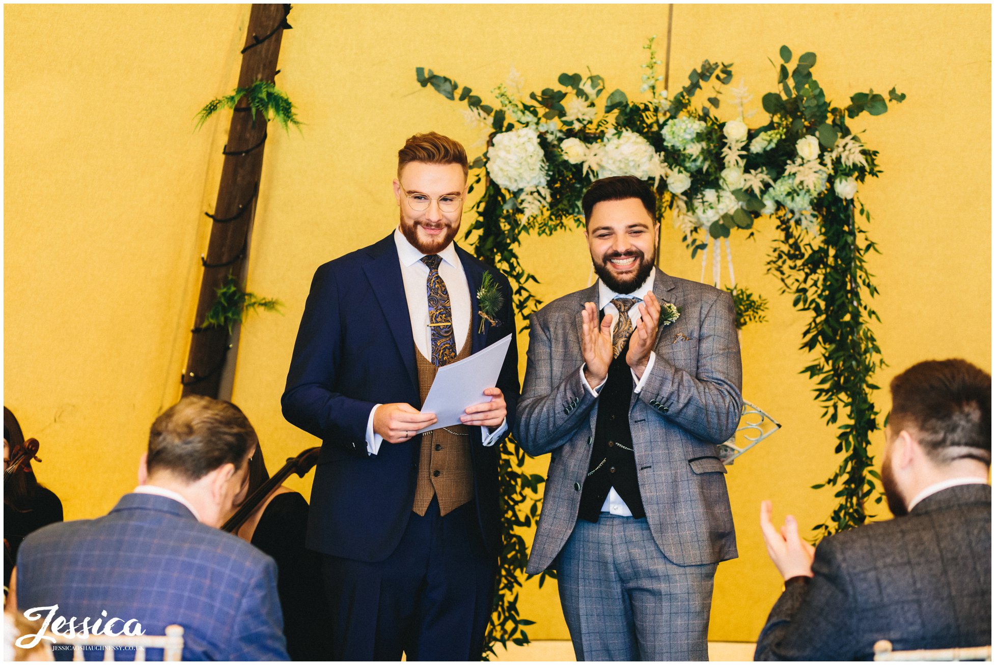 Grooms say their vows to each other at their lake district wedding