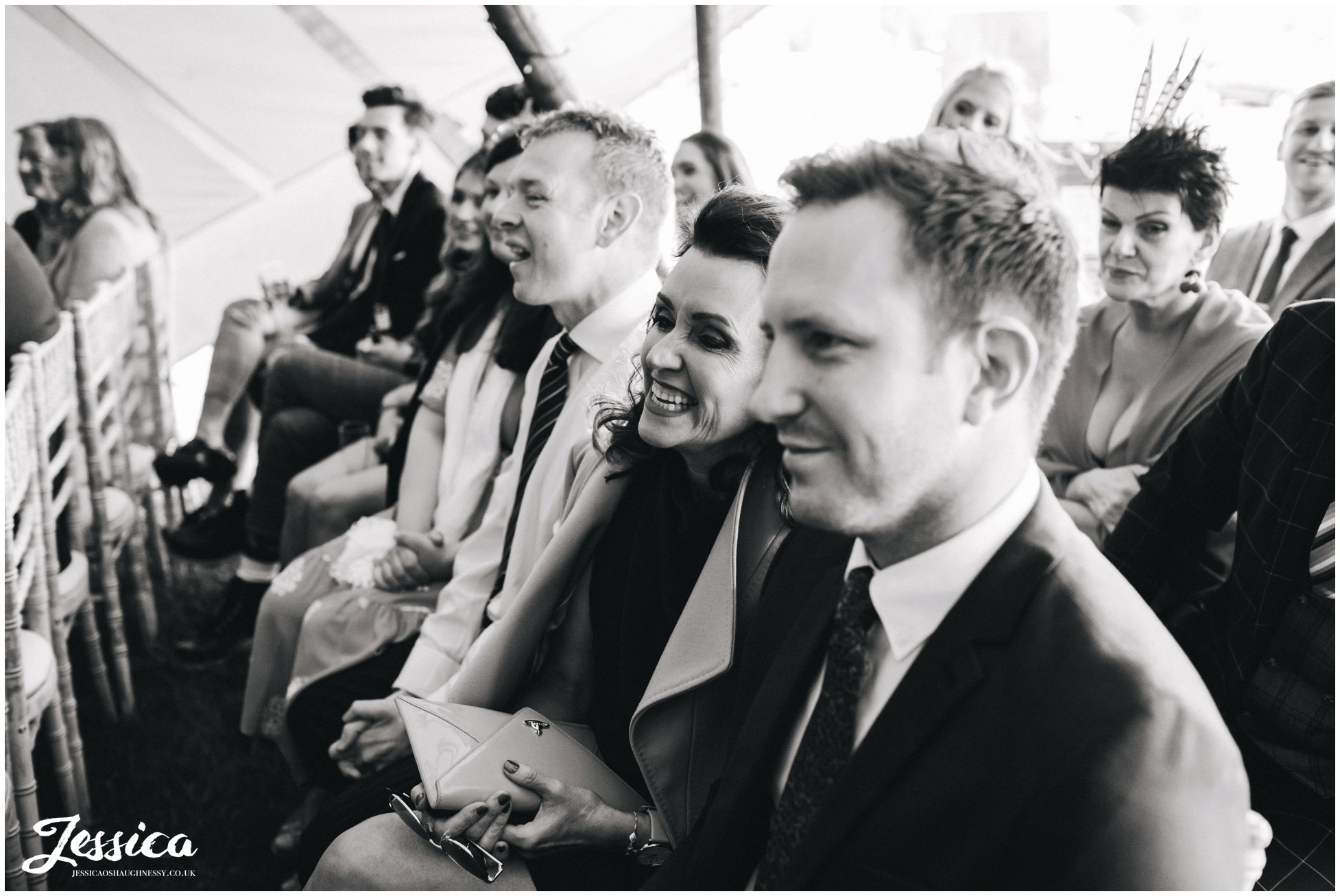 wedding guests enjoy the speeches during the tipi ceremony