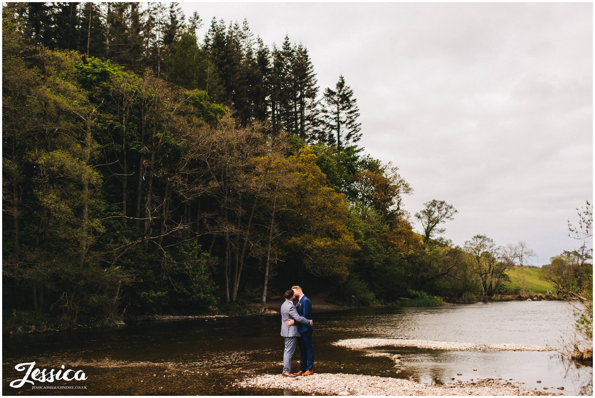 the couple share a kiss down by the river in pooley bridge