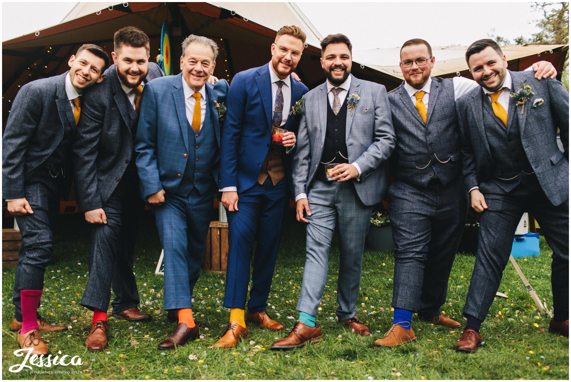 the grooms &amp; groomsmen show off their rainbow socks