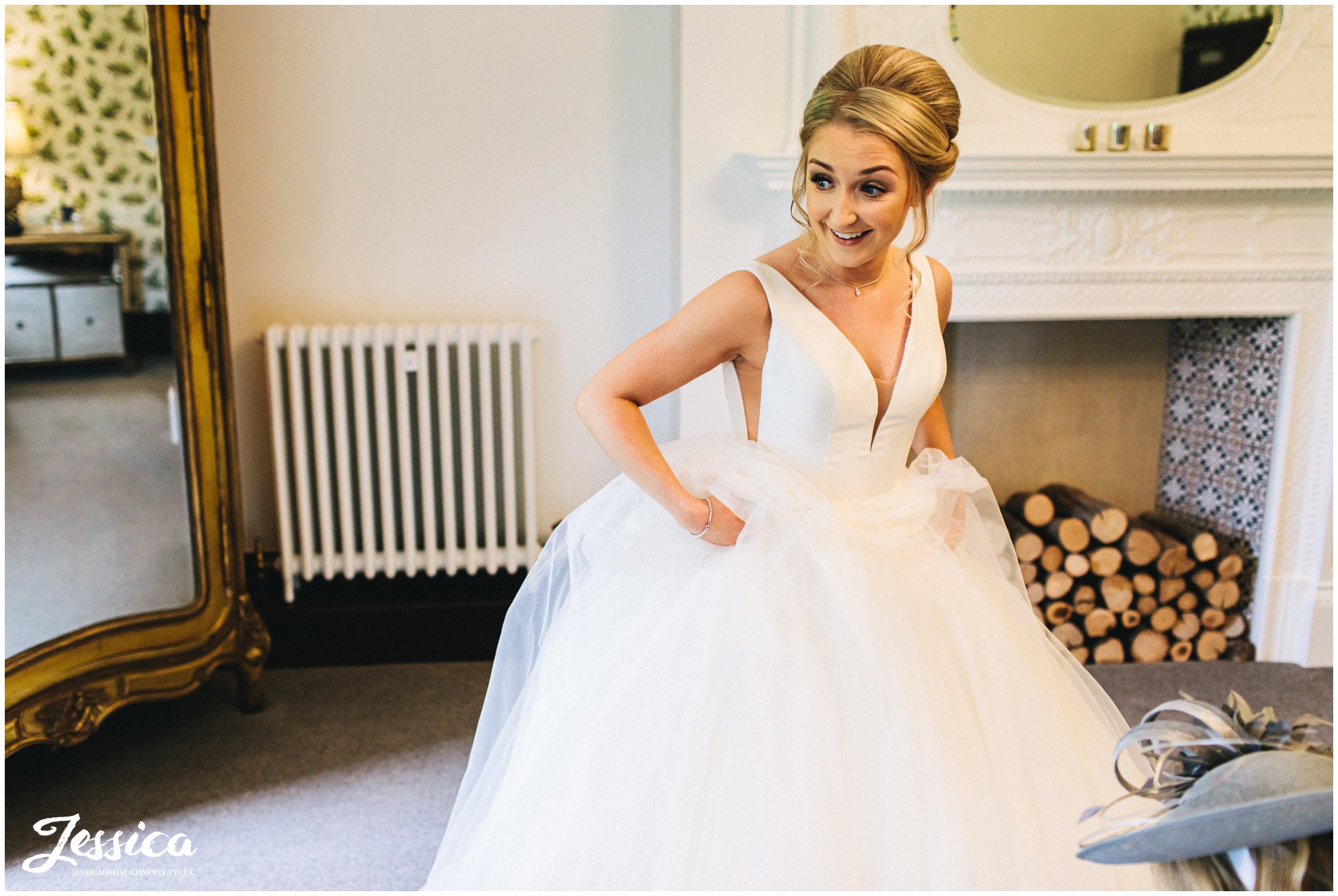the bride gets into her wedding dress