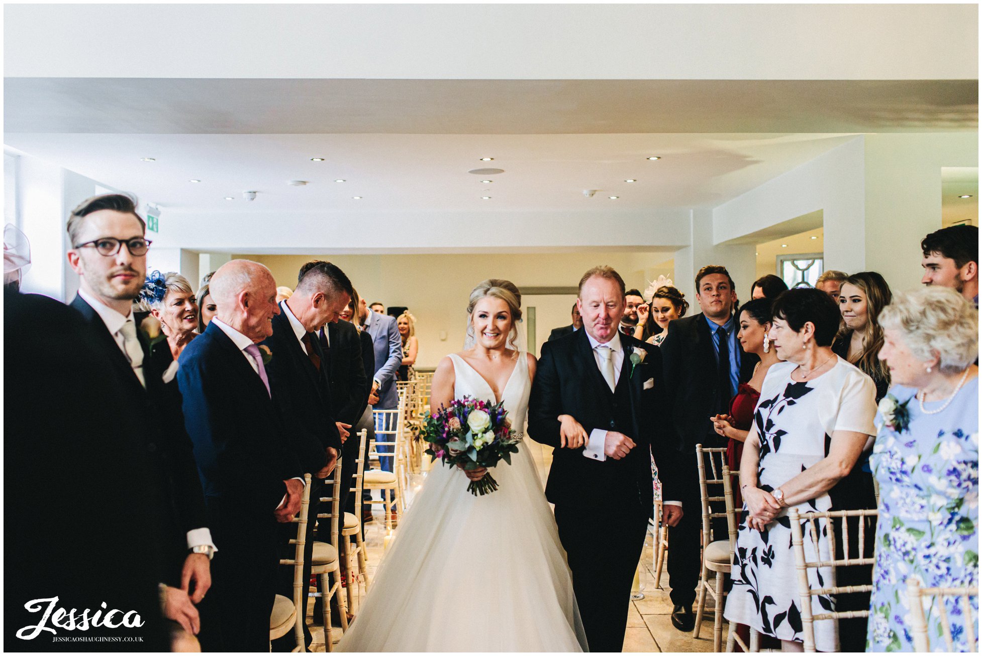 bride walks down the aisle at tyn dwr hall