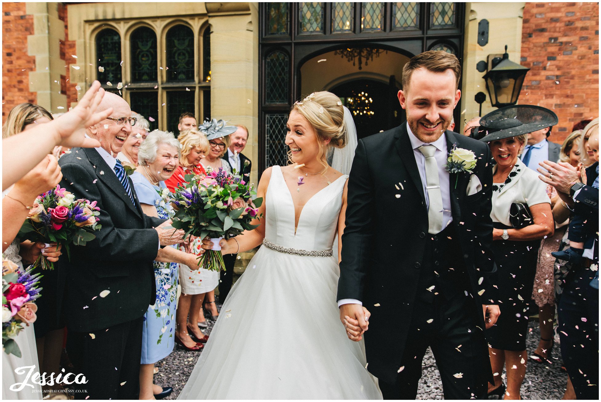 guests throw confetti over the couple