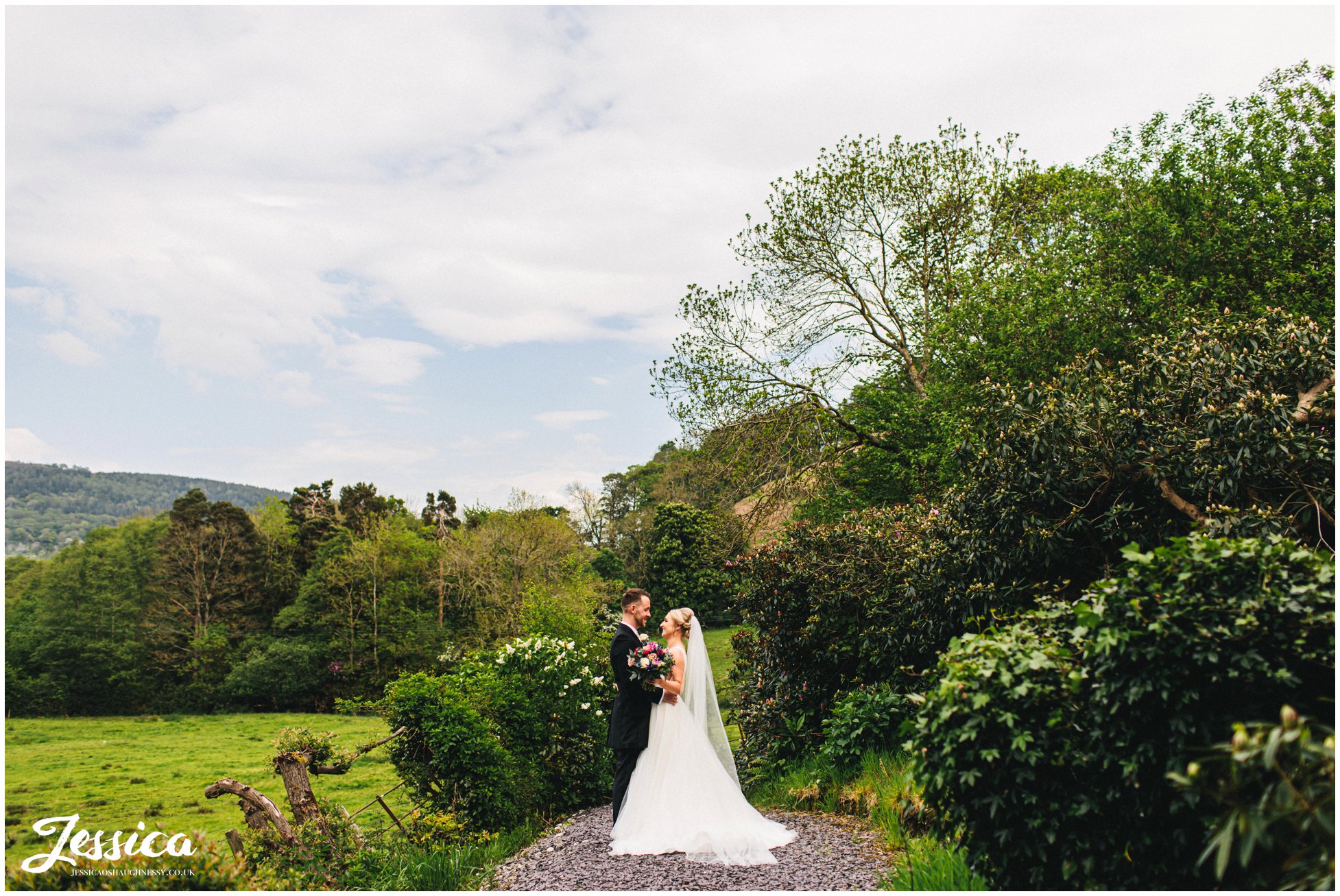 couple kiss in the grounds of tyn dwr hall