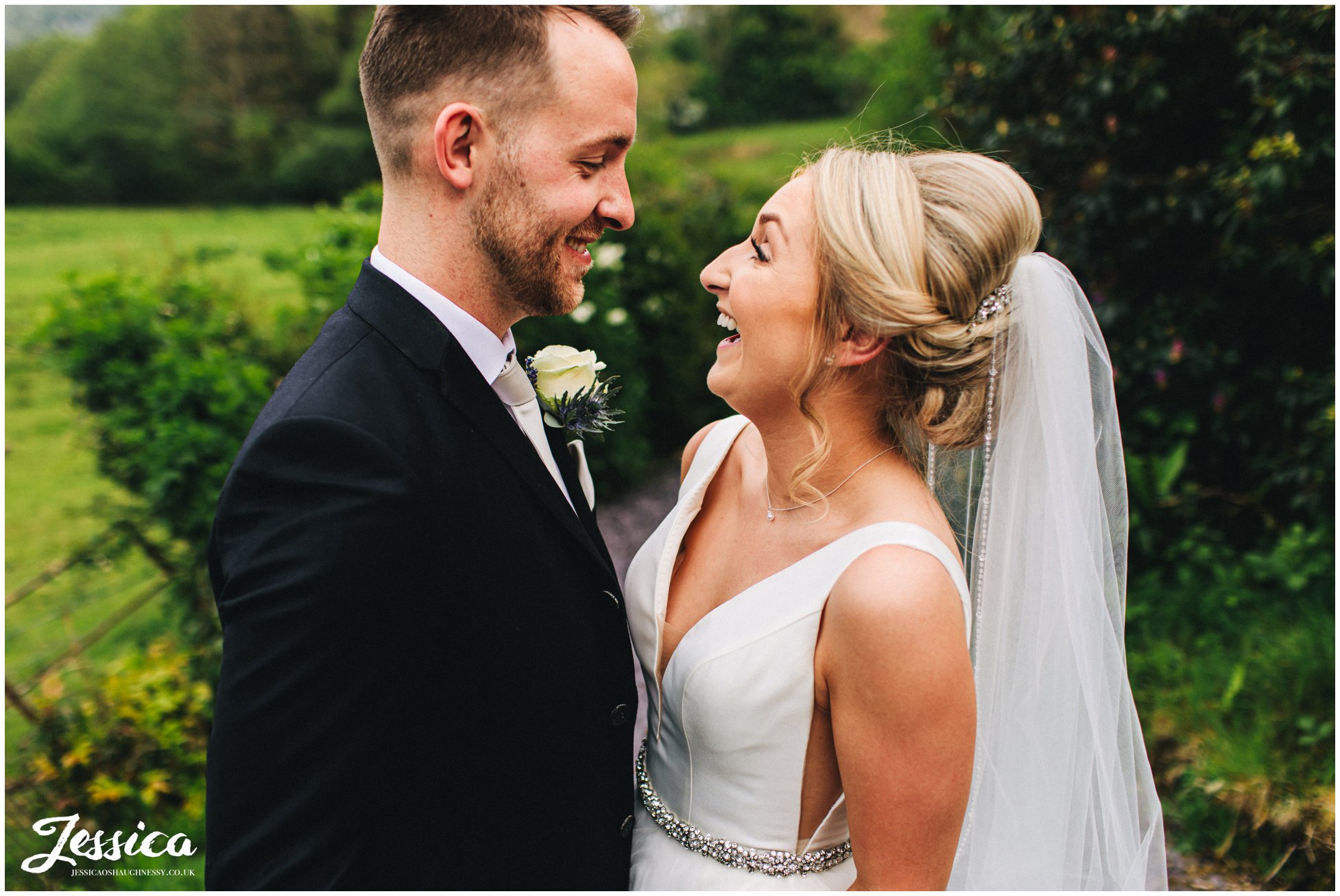 husband &amp; wife laugh with each other after their ceremony