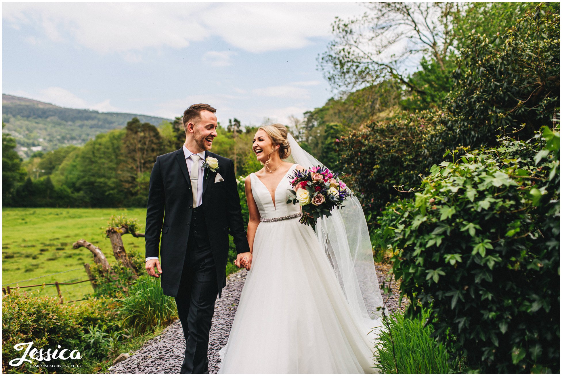 couple walk holding hands on their wedding day