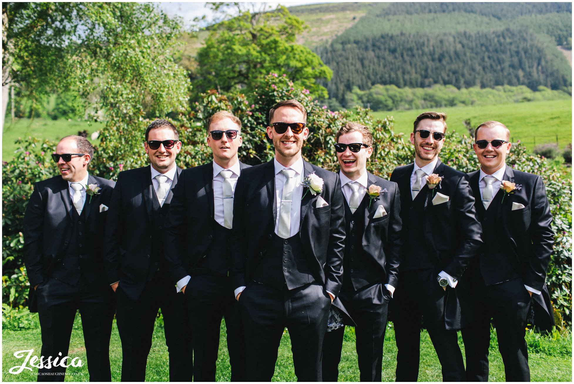 groom &amp; groomsmen pose with sunglasses