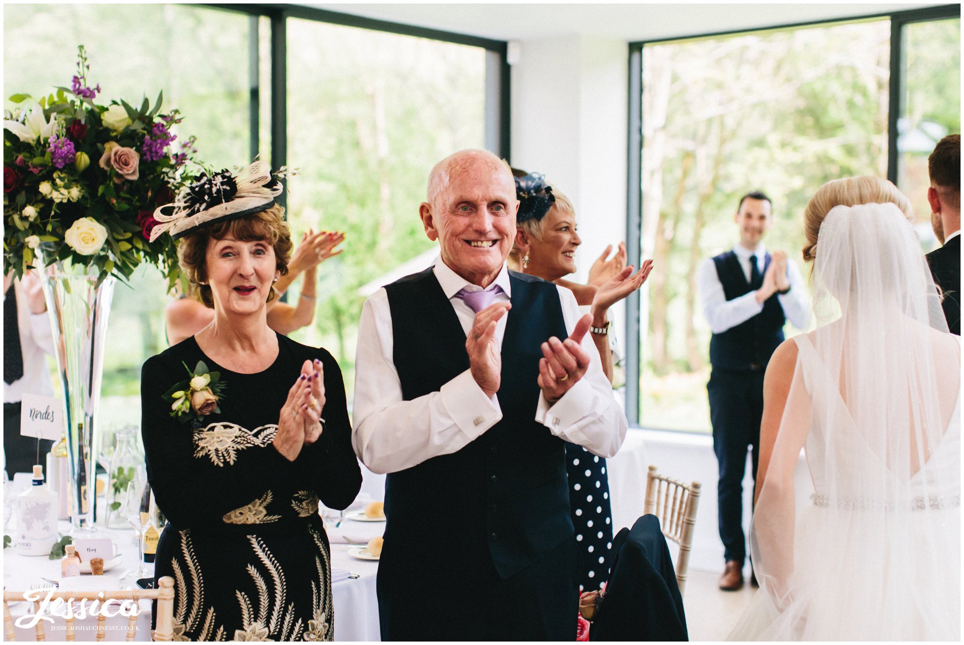 guests cheer as the couple enter