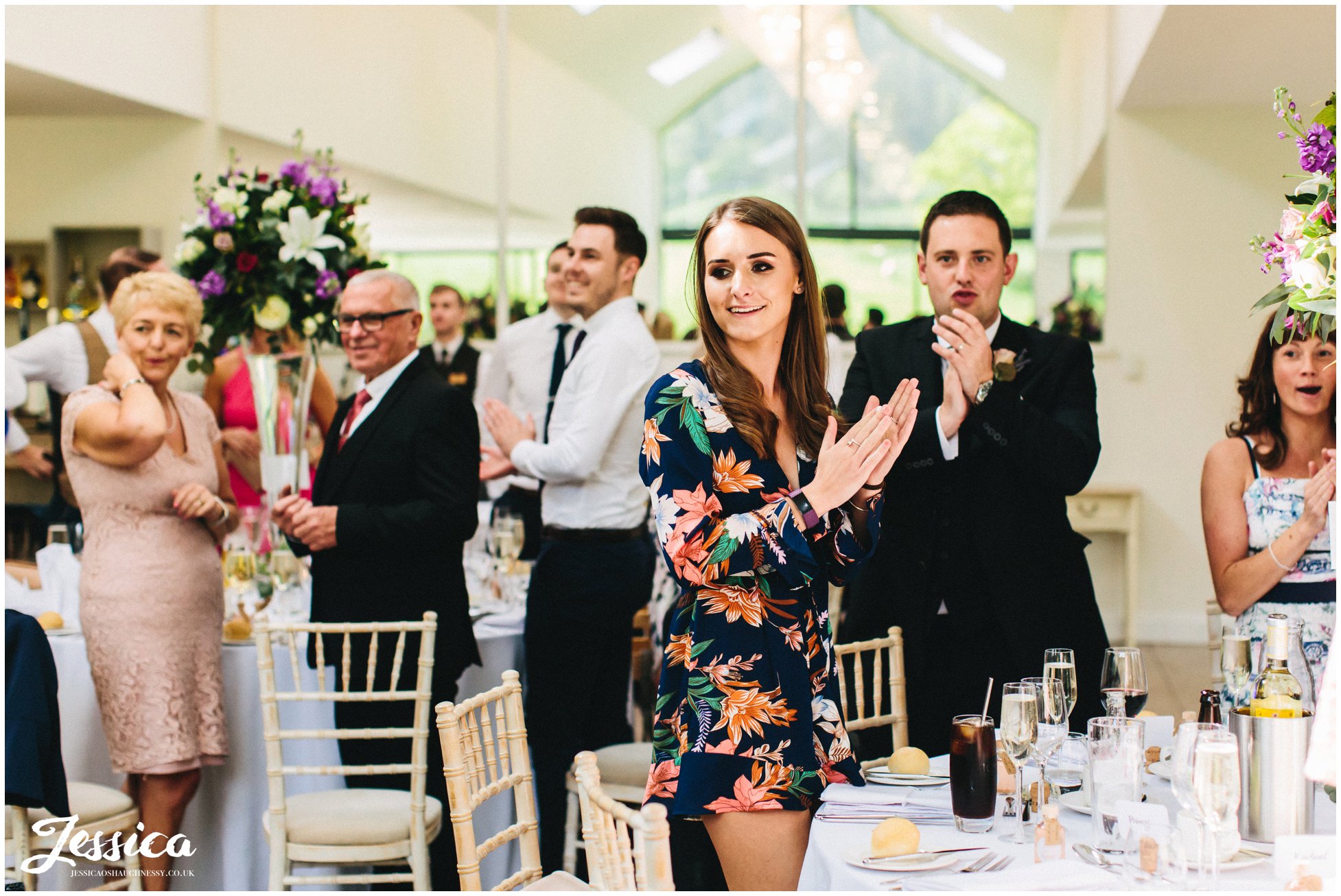 wedding guests clapping as the couple enter