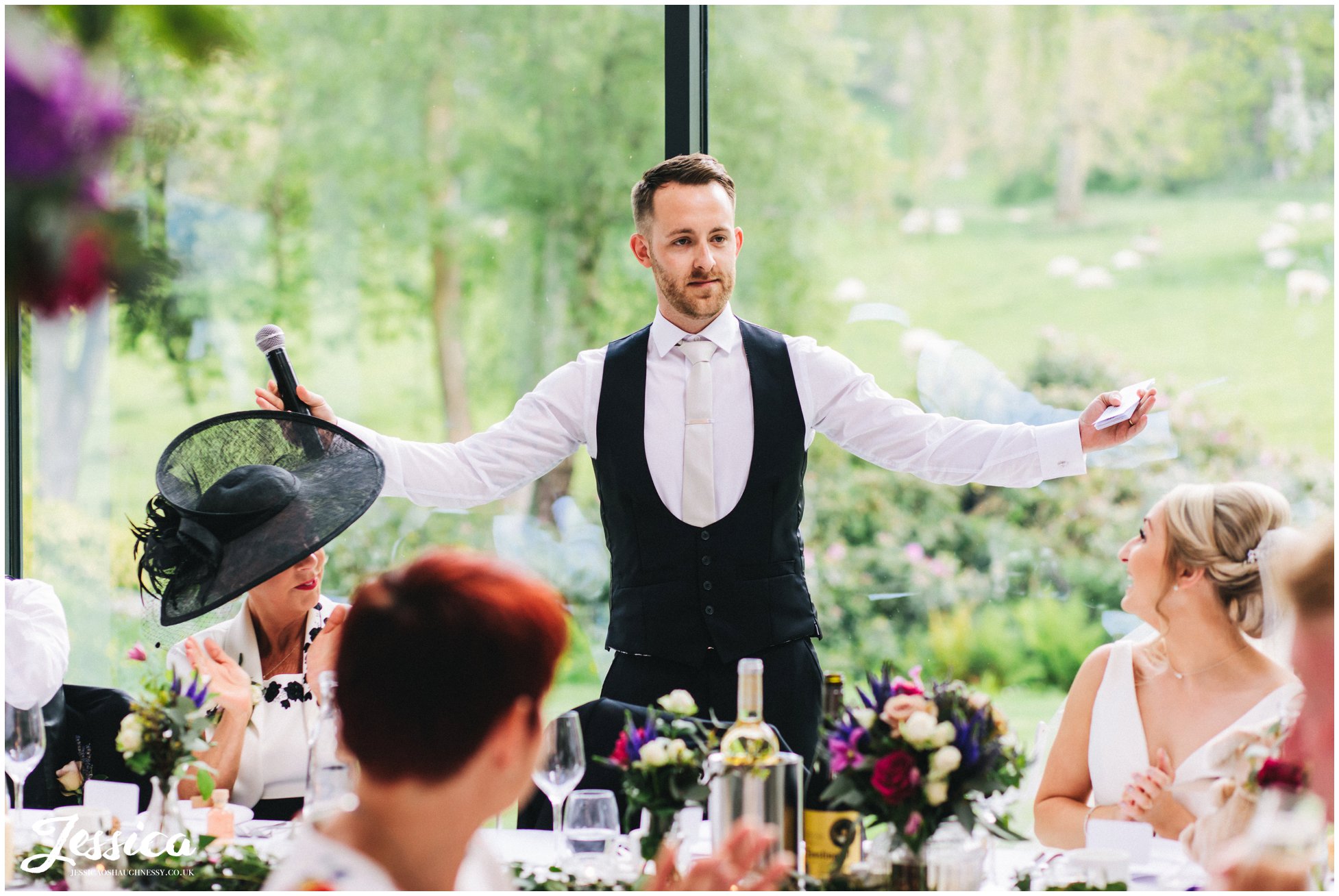 groom stands to start his wedding speech