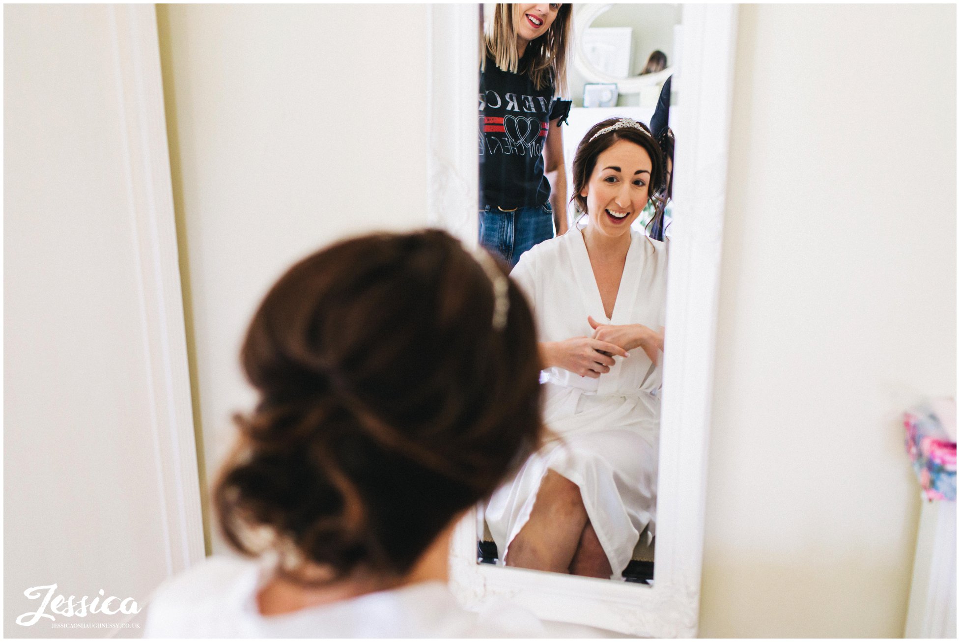 bride gets her hair done on the morning of her wedding