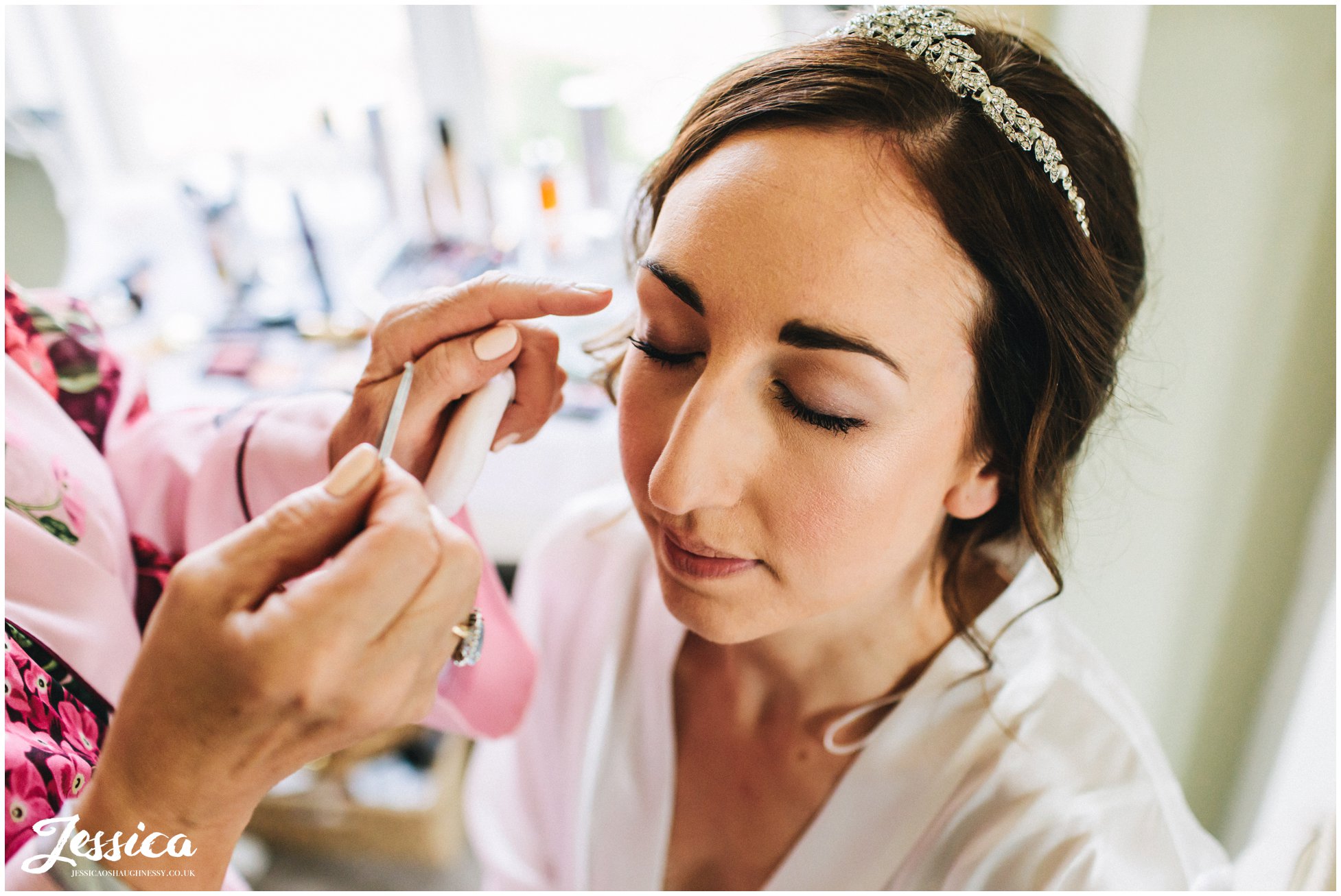 bride has her makeup applied