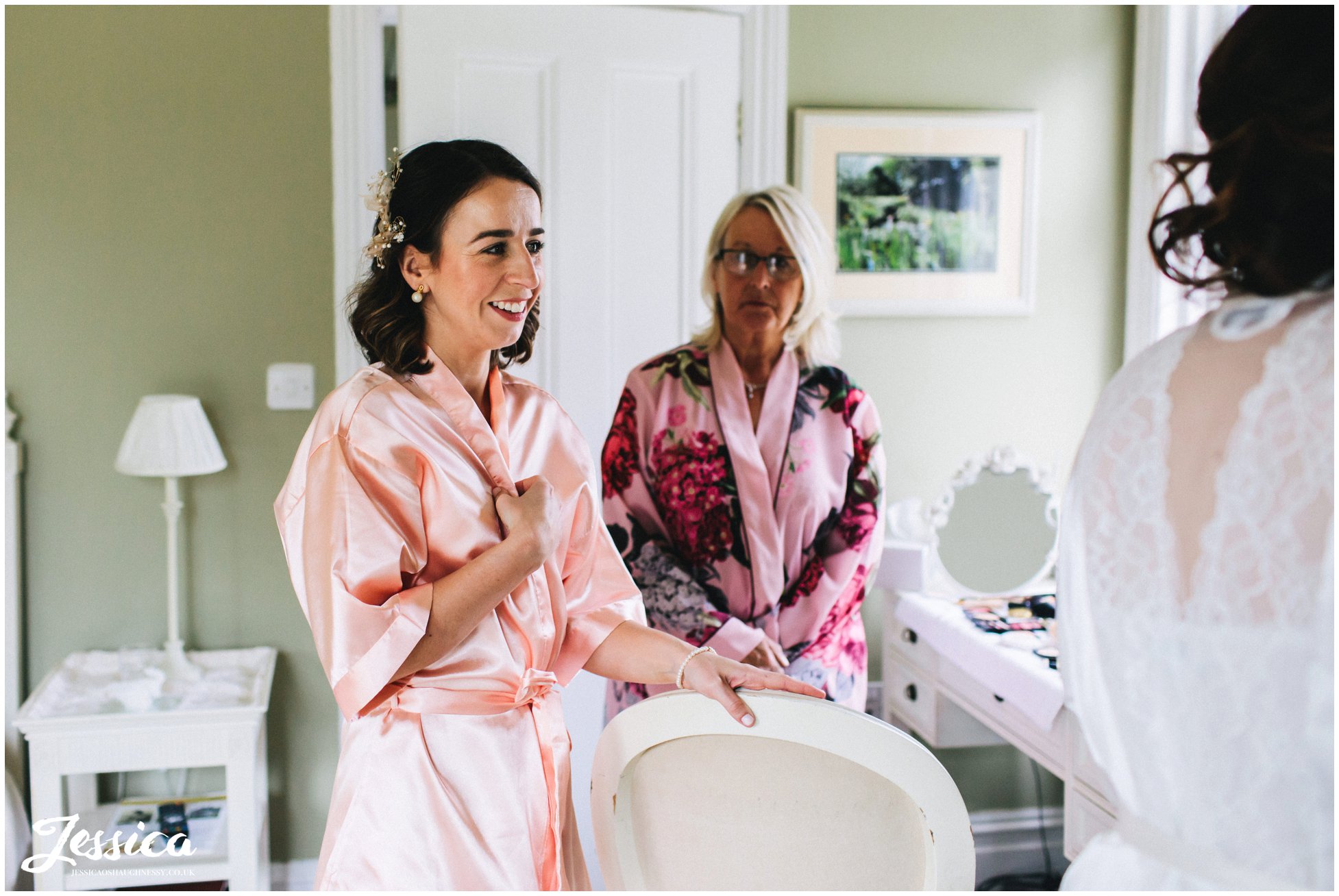 the brides sister &amp; mother admire the brides makeup