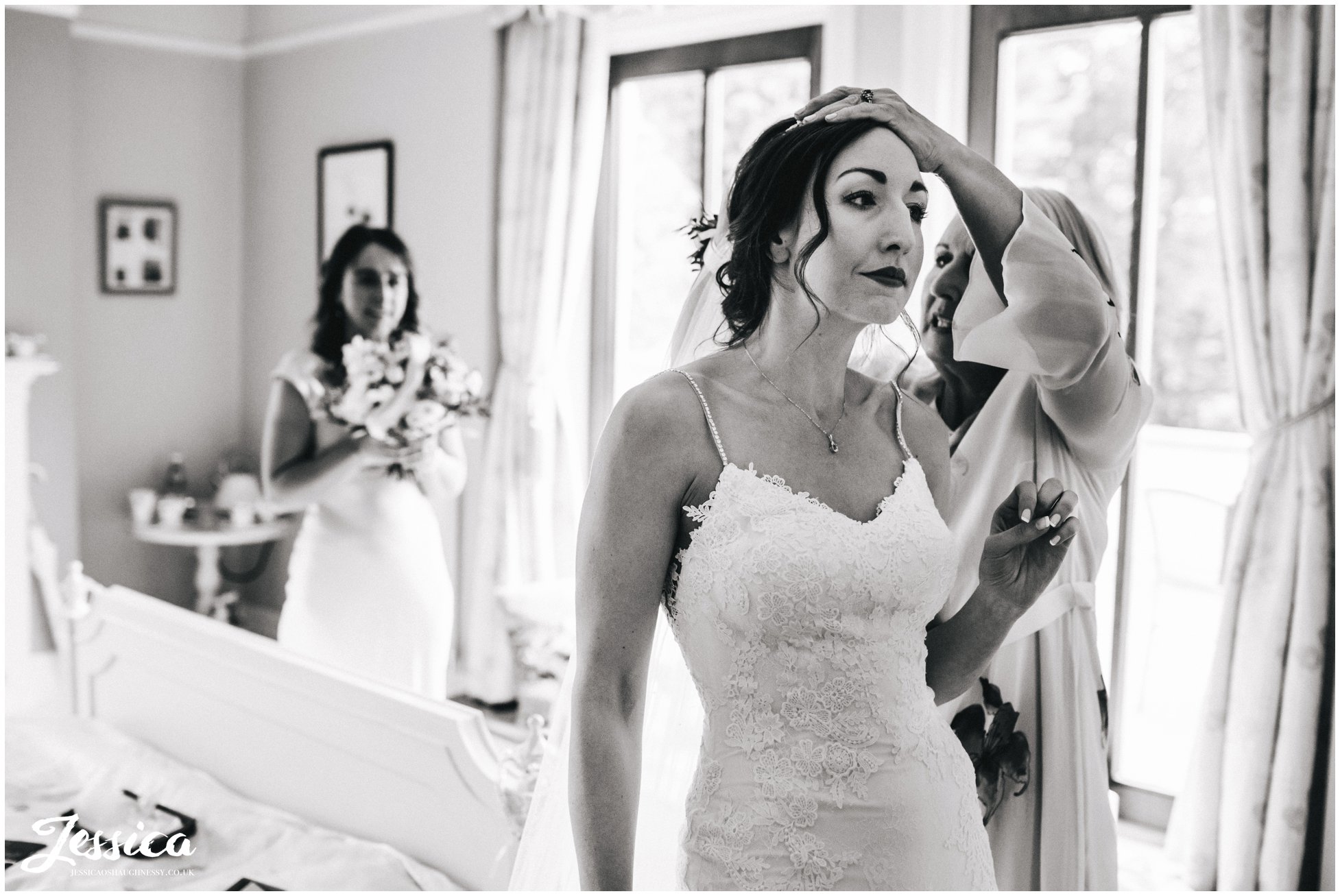 the bride has her veil put in ready for the wirral ceremony