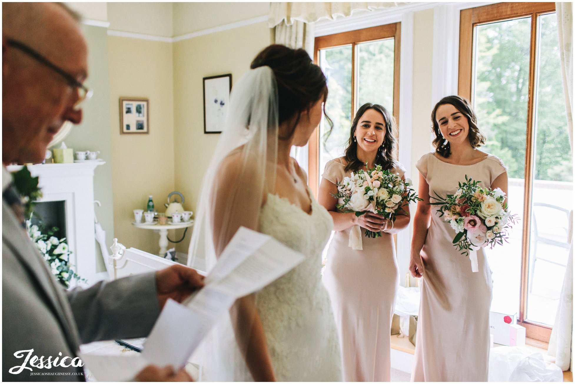bridesmaids smile as father of the bride reads letter from his daughter