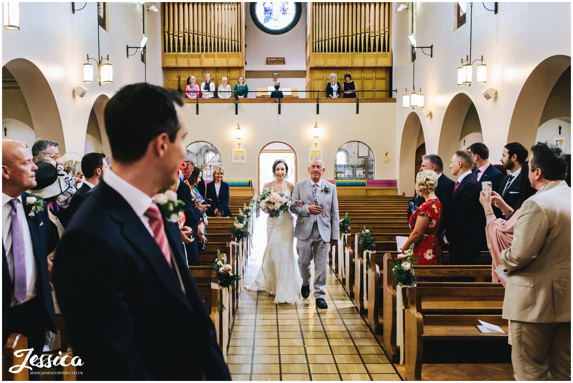 bride walks down the aisle at wirral church