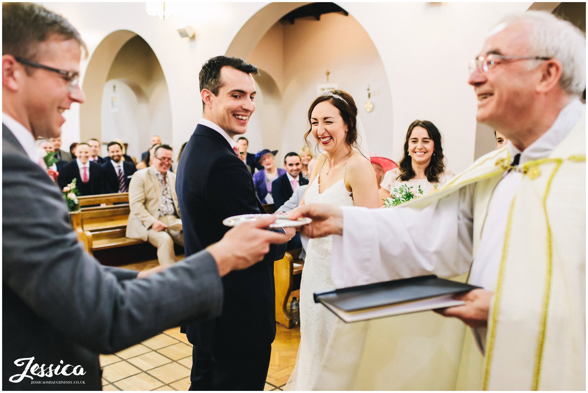 best man stands to deliver rings to the couple