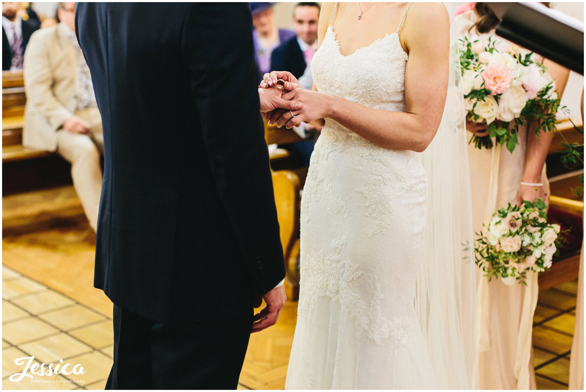 bride & groom exchange rings at the wirral church wedding