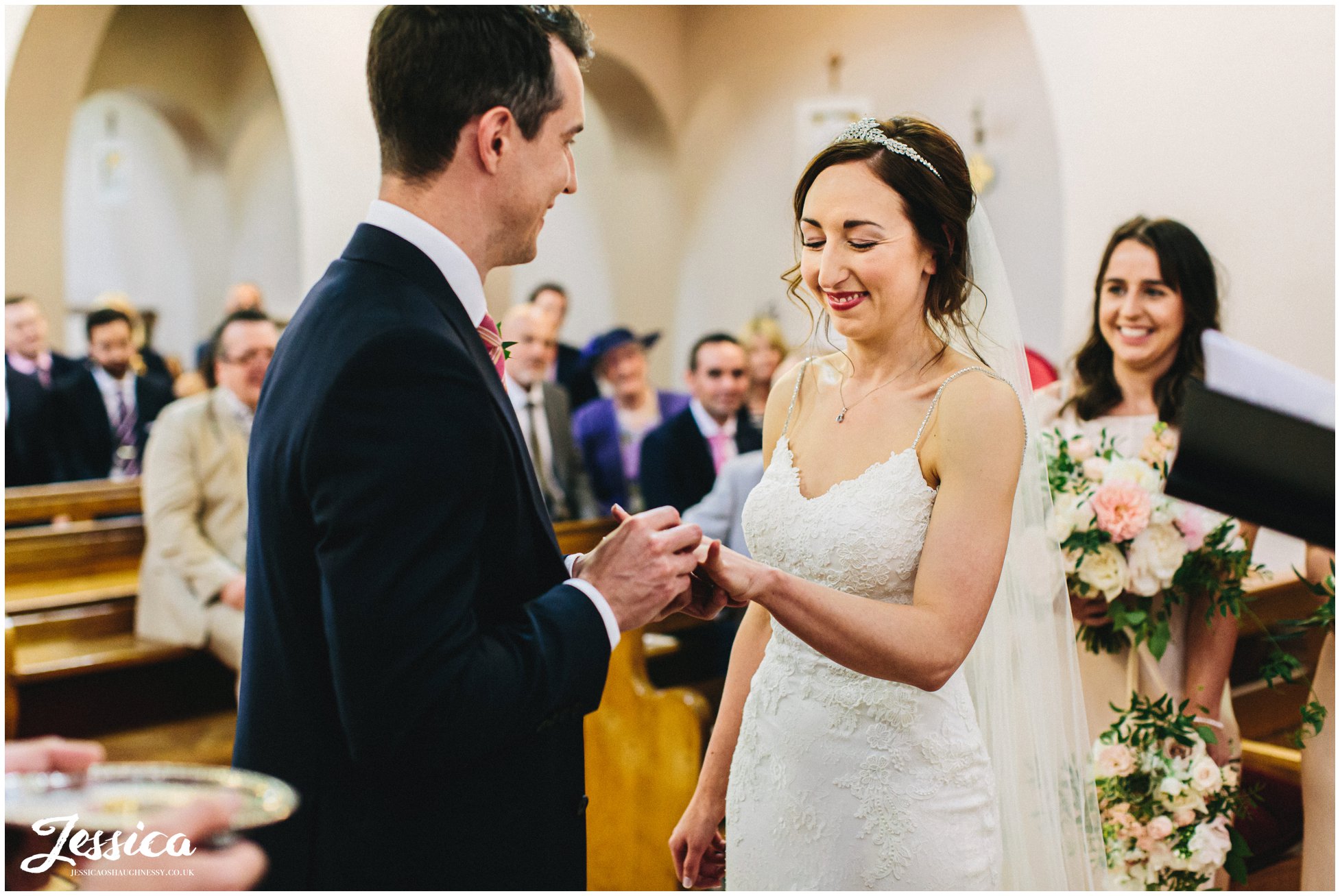 groom puts on the brides wedding ring