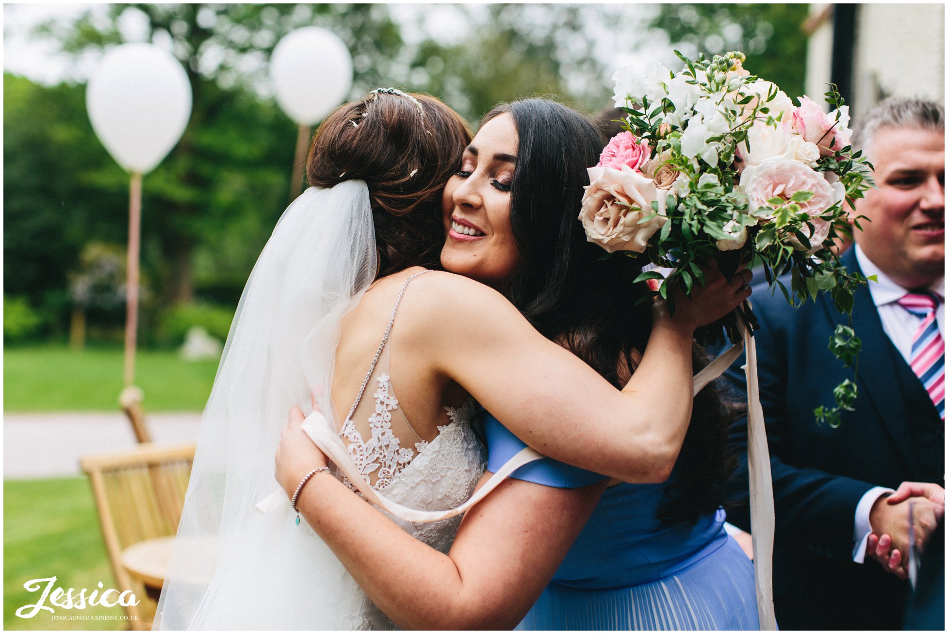 bride hugs the guests as they arrive at the reception