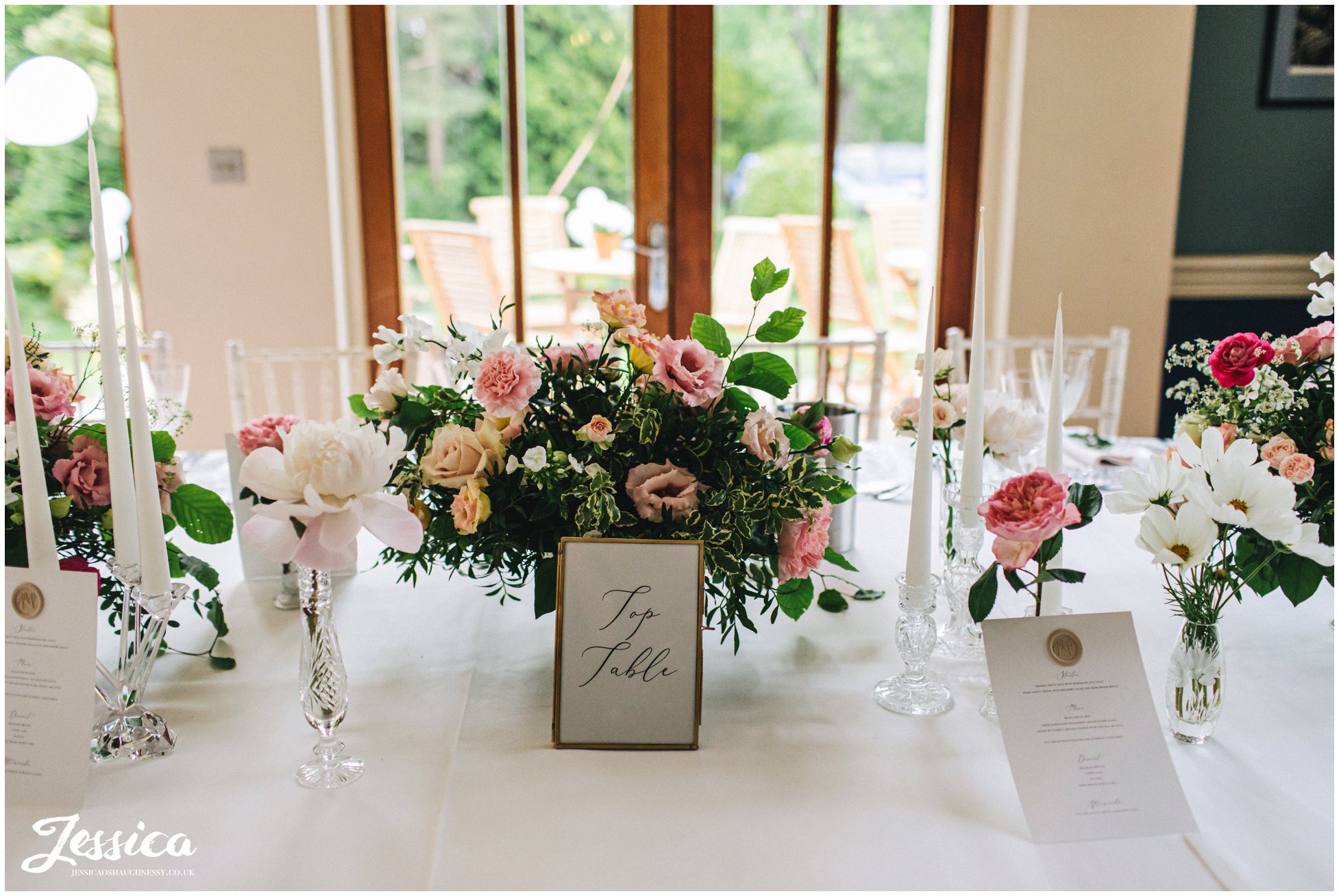 pink florals decorate the wedding tables