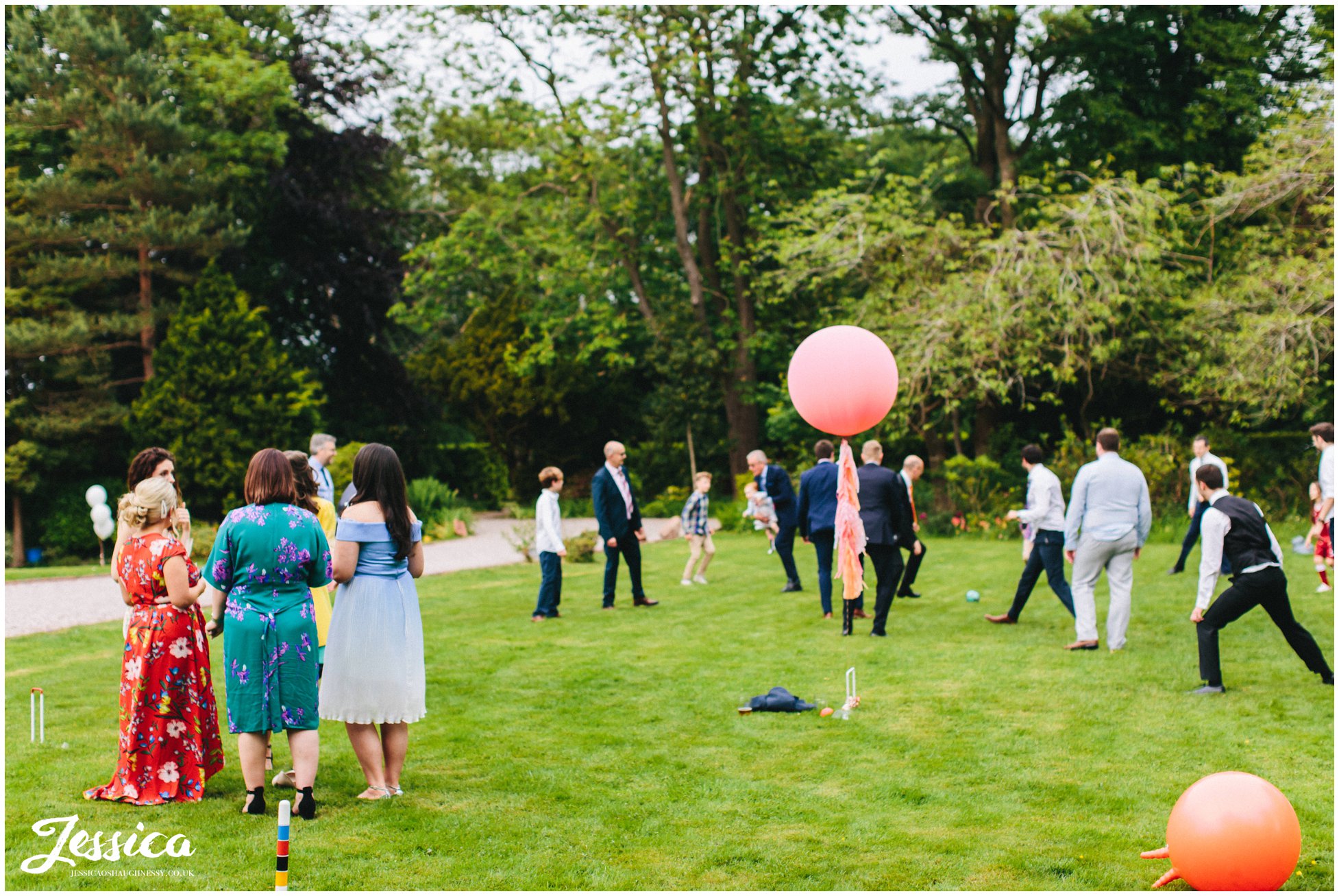 men play football and the women watch at mere brook house wedding