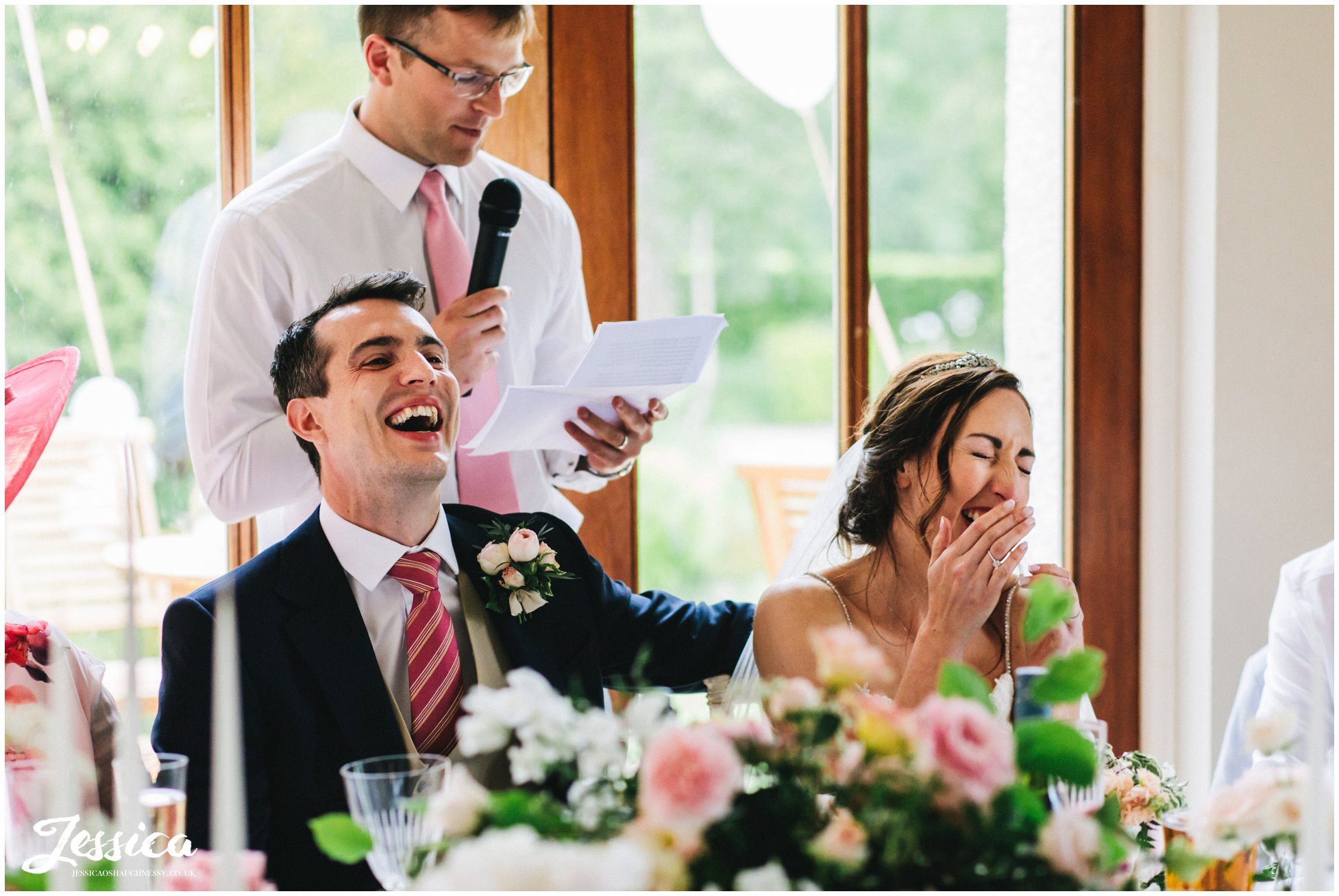 bride &amp; groom laugh at the best man's speech
