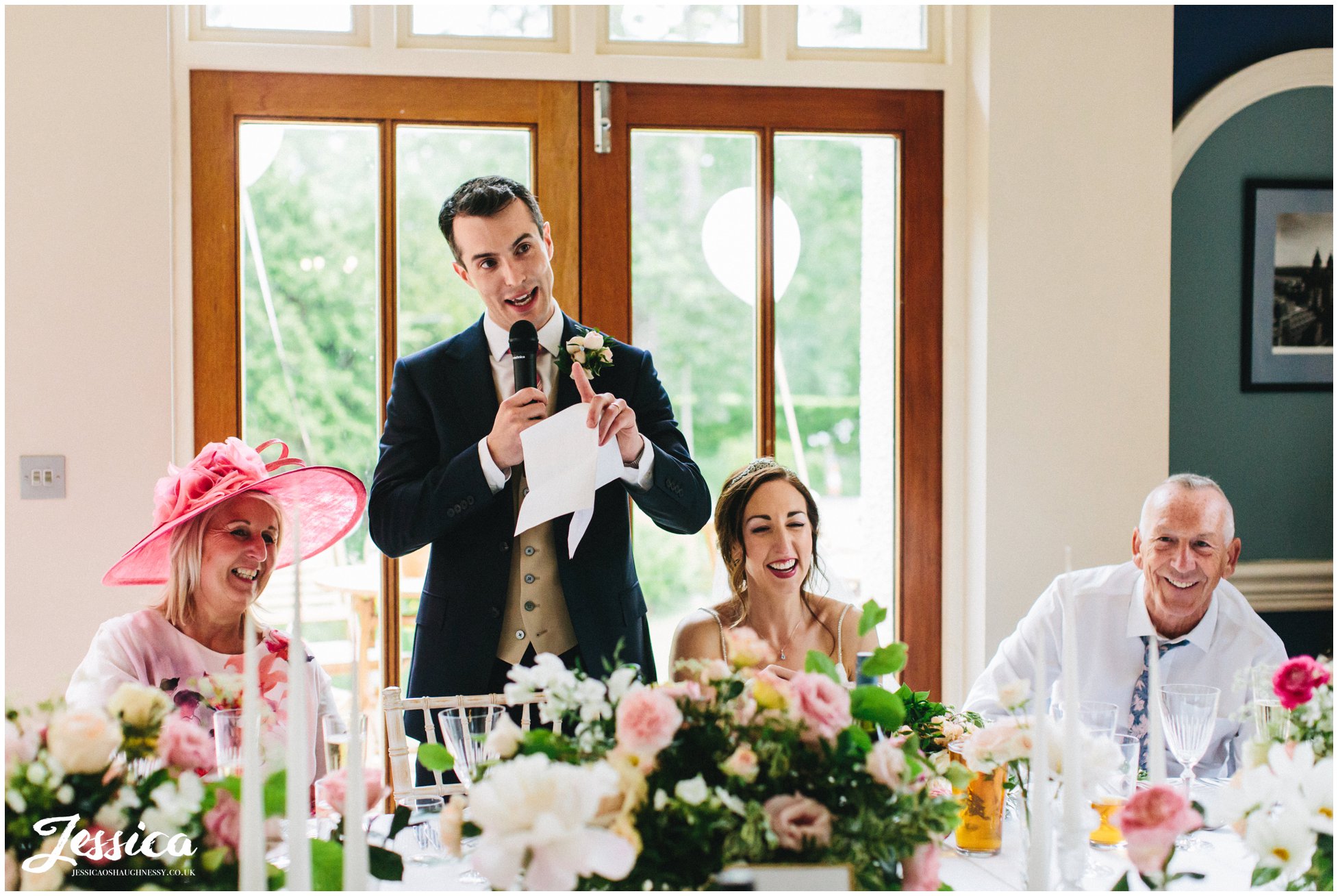 groom stands to deliver his speech