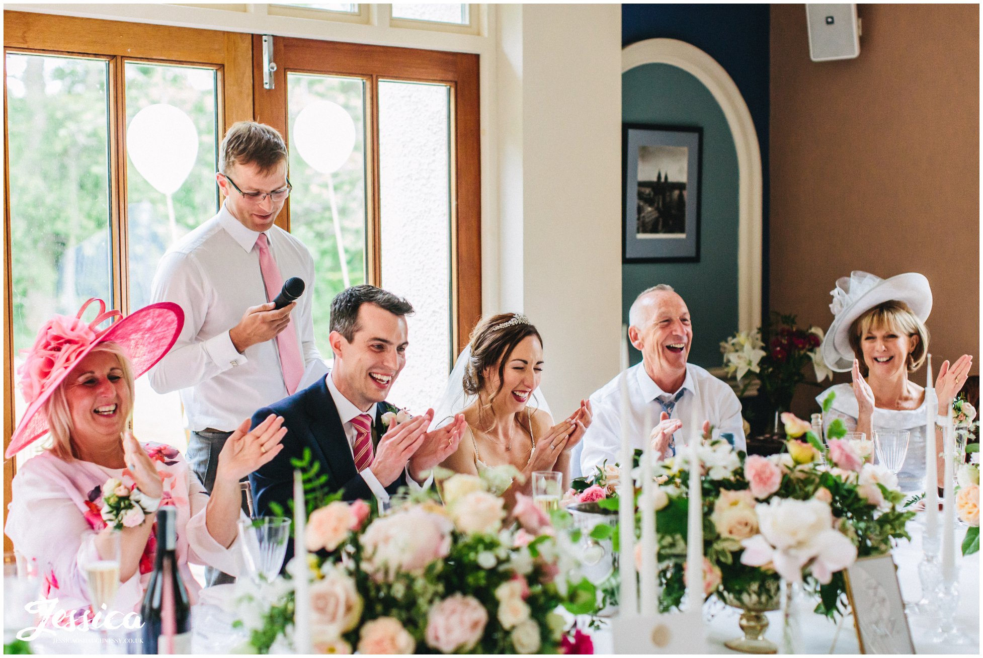 the top table applaud the best man after his gives his speech