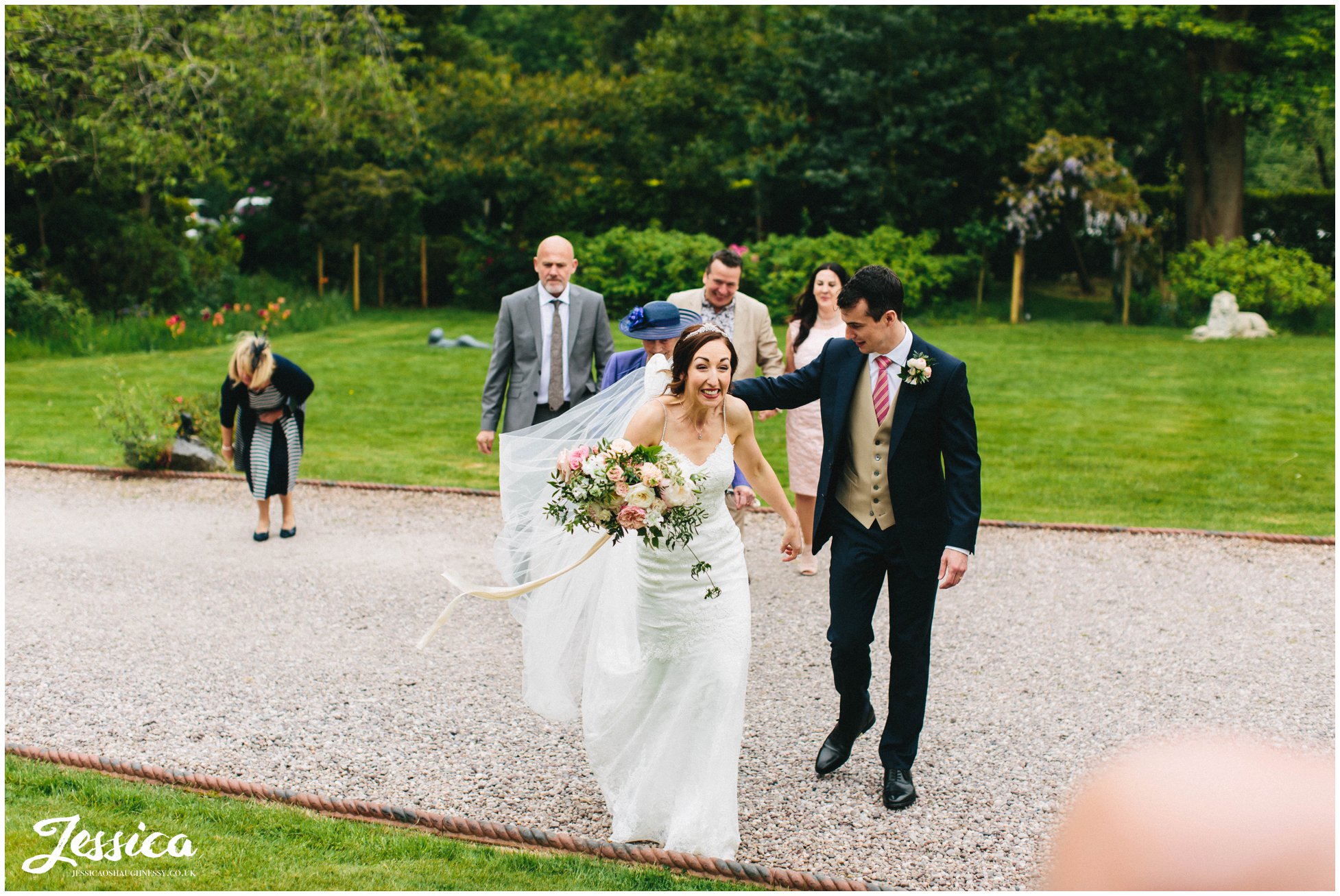 bride excitedly greets guests at mere brook house