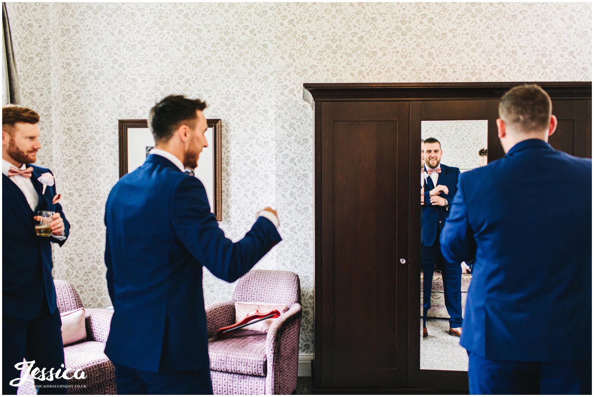 groomsmen get ready in a mottram hall suite 