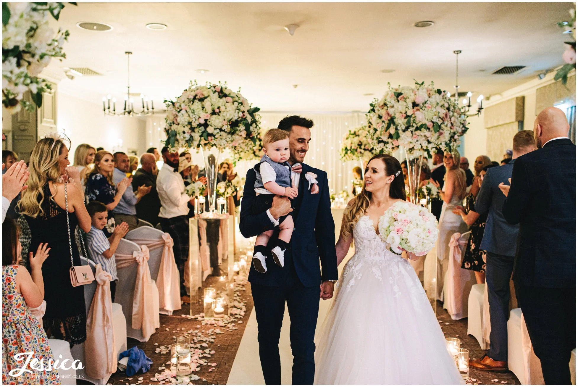 the newly wed's walk down the aisle with their son