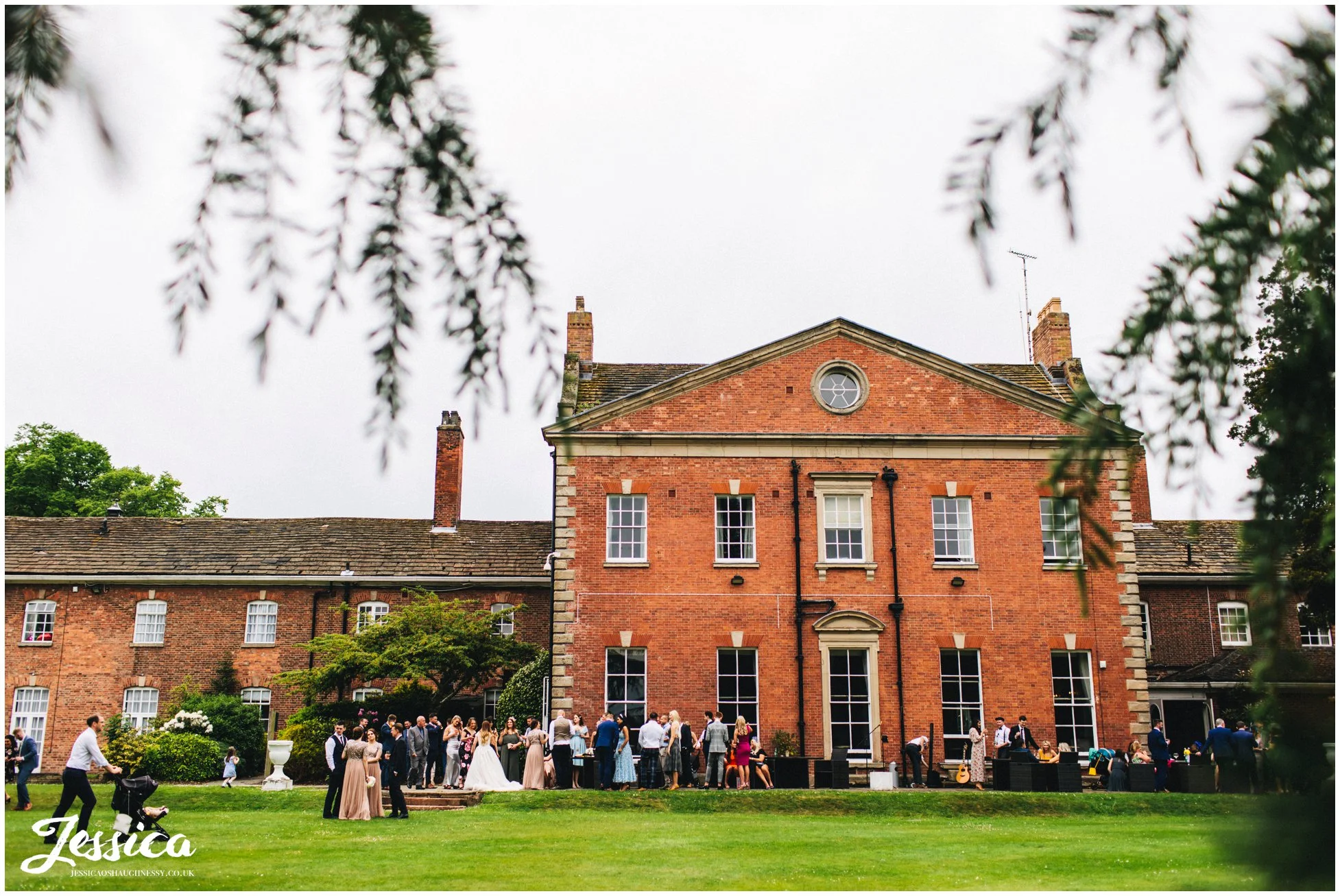 wedding guests enjoy drinks reception on the terrace