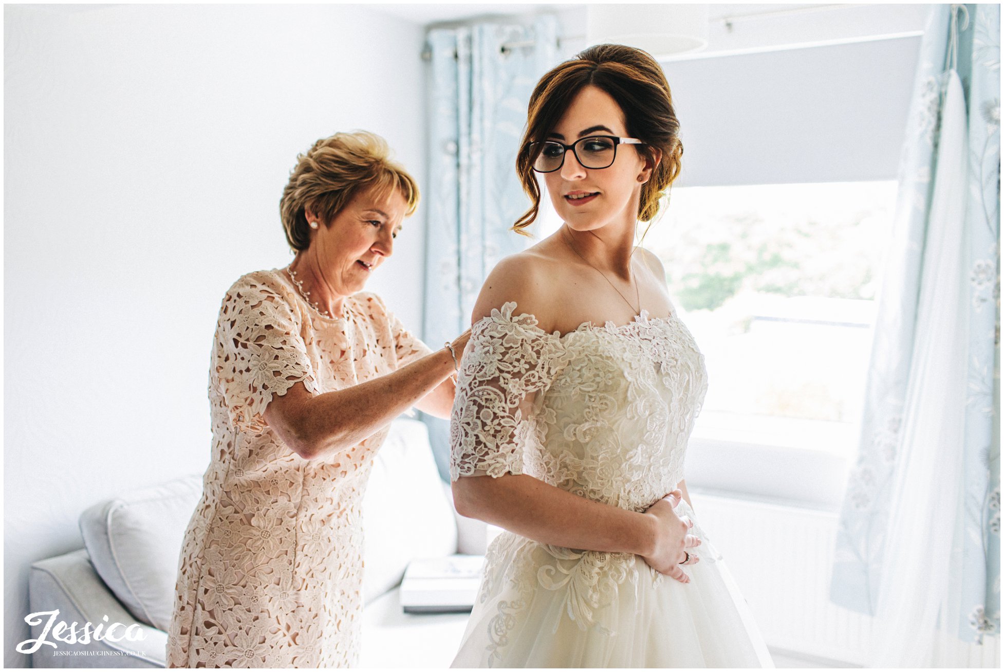 Bride gets into her wedding dress before the north wales wedding