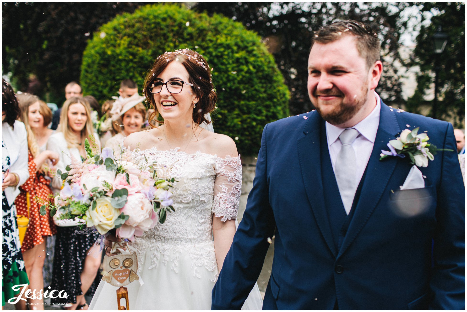 husband and wife walk through confetti line outside the church