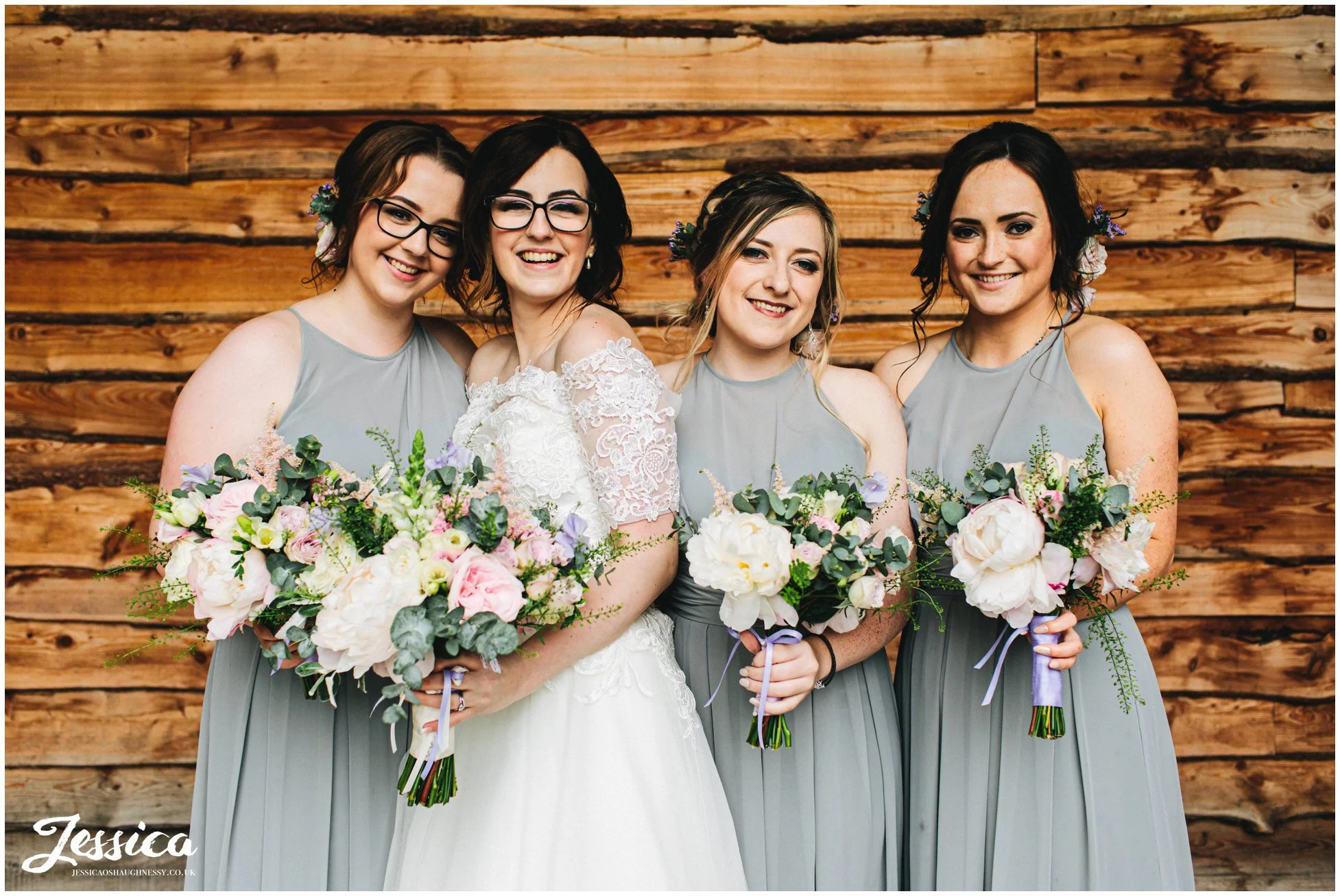 bride poses with her bridesmaids at tower hill barns